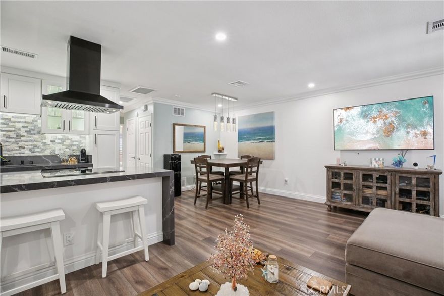 Welcome to Harbor Heights Villas, a beautifully maintained coastal community just minutes from Sunset Beach, Bolsa Chica Wetlands, and the scenic trails and waterways of Huntington Harbour. This upgraded 2-bedroom, 1-bath upper-level end unit offers modern style and comfortable living in one of Huntington Beach’s most desirable neighborhoods. The home features wide-plank flooring, plantation shutters, recessed lighting, and an open-concept layout filled with natural light. The remodeled kitchen includes updated cabinetry, sleek stone countertops, a designer tile backsplash, and a breakfast bar that flows seamlessly into the living and dining areas. The bathroom has been thoughtfully renovated with contemporary finishes, tile detail, and a glass-enclosed shower. Both bedrooms are spacious with ample closet storage and ceiling fans. Additional highlights include a private balcony entrance area, access to the community’s serene greenbelts, and a shared garage with one dedicated parking space plus additional community parking. Conveniently located near shopping, dining, everyday amenities, and some of the area’s best outdoor recreation. A fantastic opportunity to own a turnkey home in a highly sought-after Huntington Beach enclave.