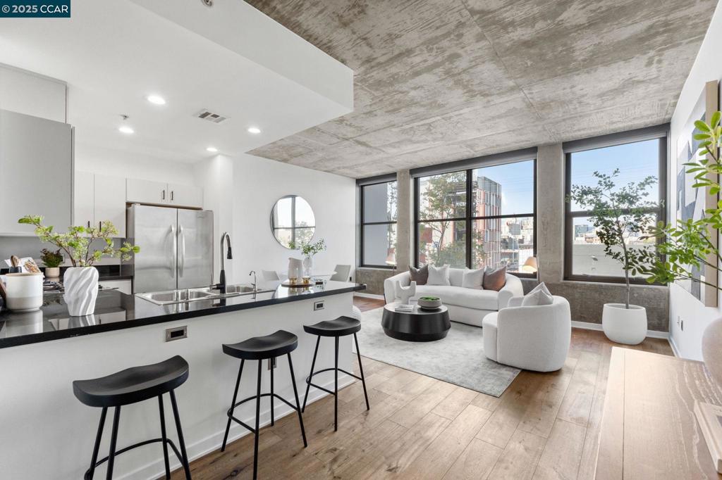 Located in the heart of Oakland’s vibrant Jack London Square, 311 2nd Street #405 offers the ultimate blend of modern loft living and unbeatable lifestyle convenience. This stylish 1-bedroom, 1-bath luxury condominium at The Bond features soaring ceilings, abundant natural light, and an open industrial-inspired floor plan accented by designer finishes, fresh updates, and a neutral modern palette. The kitchen boasts stainless steel appliances, quartz countertops, and freshly painted cabinets, while the bathroom has been recently refreshed with a new vanity, counters, flooring, and an updated shower. Enjoy the ease of in-unit laundry, central heating/cooling, and a secured deeded parking space, along with upscale community amenities including 24-hour concierge, fitness center, business lounge, landscaped courtyard, BBQ areas, and even a dog park. Step outside and experience the energy of Jack London Square, just moments from breweries, wine bars, waterfront dining, and weekly farmer’s markets, with quick access to BART, Amtrak, the Oakland-Alameda Ferry, and major freeways for seamless commuting. Offering a fun, dynamic vibe with modern comfort, this loft is the perfect choice for anyone seeking a chic urban lifestyle in one of Oakland’s most exciting neighborhoods.