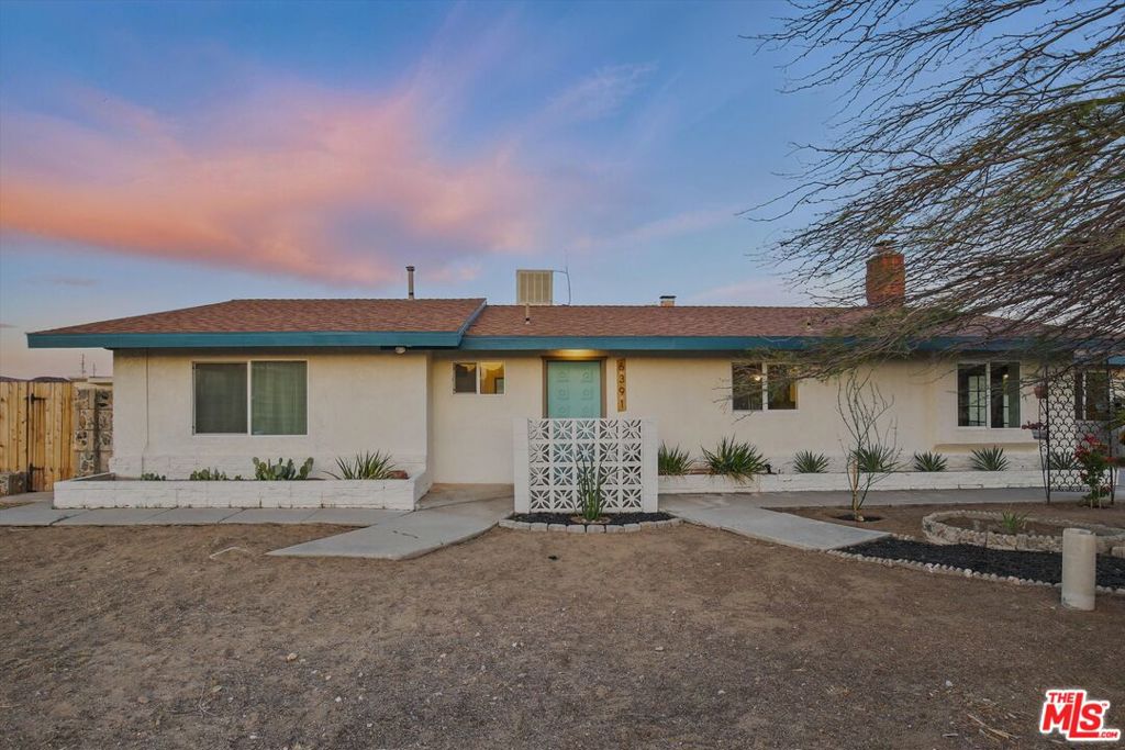 ATTN: Owner Users Investors.Nestled just minutes away from vibrant Joshua Tree village and breathtaking National Park, this midcentury ranch compound is a rare find! With two separate houses and several outbuildings, it's perfect for someone looking to invest or create a relaxed live/work retreat. Set on a spacious 1.25 acre lot, plus an extra 1.25 acres of fenced land that can be purchased seperatly, you've got plenty of room to build or just soak up the natural beauty.The main house is flooded with natural light, offering a spacious open floor plan with two cozy living areas, each with its own wood burning fireplace. One even has a spit BBQ. The kitchen is a cook's dream with stainless steel appliances, new butcher block countertops, and a chefs sink. You'll find tons of built-in storage, a fully equipped laundry room, and over 1,900 square feet of living space. There's also an extra 650-square-foot suite that's ideal for a main bedroom, art studio, or guest area, featuring its own entrance, large walk-in closet, and a beautifully remodeled bathroom. You've got all the comforts covered with natural gas for cooking and heating, radiant electric heating, and fireplaces for winter, plus evaporative cooling and AC for the summer months. Enjoy outdoor living with two patios, a lovely shaded front yard and a pergola in the backyard for entertaining.The second house is a charming 1,000-square-foot space with two bedrooms, a remodeled bathroom, and a modern eat-in kitchen with access to a private backyard. It's tucked away from the street and includes an oversized one-car garage, making it a perfect rental unit.The outbuildings are ideal for storage or creative projects; one cabin even comes with electricity and an underground wine cellar. The entire 1.25 acres is fenced with multiple gates and has two driveways, including one that leads to the backyard and RV parking. There's also a large concrete slab ready for new possibilities like a garage or horse stables. Plus, it's a horse-friendly property and includes its own water well for irrigation, which is a rare find in town. Utilities are easy with city water, sewer, natural gas, and electricno need for septic or propane. Each house has separate meters, privacy fencing, and individual driveways and parking areas, making it convenient if you want to rent them out.It's not common to come across a property in Joshua Tree/Yucca Valley with such original character and features. This place is packed with potential for you to make it your own or simply enjoy everything it already offers.