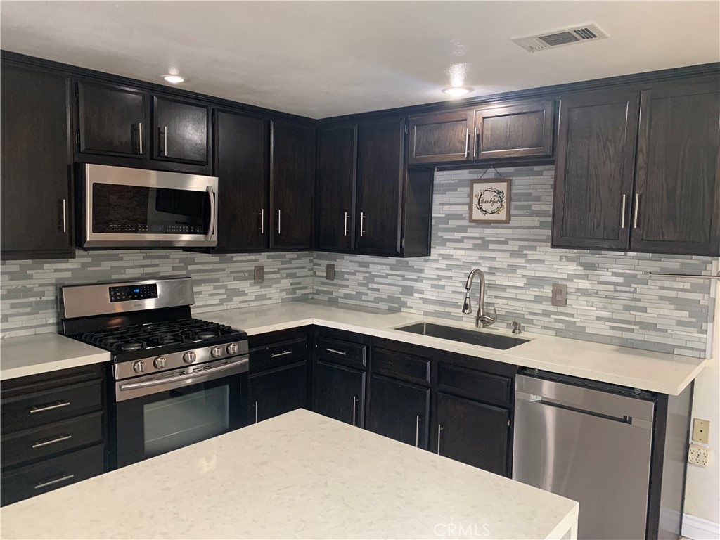 Gated Community! A Pine Ridge Villas Charming 2 bedroom, 1.5 bath condo w/ a 2-car attached garage!! This community is located across the street from Vallejo Middle school and just blocks from the 210/215 freeways, close to shopping & Cal State San Bernardino. New occupants will enjoy the benefit of the sparkling community pool and spa! The interior of the unit has been remodel including upgraded flooring and fixtures, Quartz countertops, an upgraded kitchen with stainles appliances (refridgerator will be removed) and a center island for additional seating. Off the kitchen is an outdoor patio area, perfect for relaxing on those cooler nights. This condo also features a cozy fireplace and beautiful custom stone wall in the living room! Just outside the 1/2 bath downstairs, the owner created a nook area that can be used for a small desk/office area. Upstairs are 2 spacious bedrooms. The primary has a custom closet with shelving and additional lighting. The shared updgraded bathroom features dual sinks Quartz counter tops, a custom 3 way tile shower and lighting with built in bluetooth and speaker. Enjoy this spacious layout w/ 1,237 square feet of interior living space! Washer/Dryer hook-ups are in the garage. Rent includes water, sewer, trash and yard care. Renters Insurance required. Good credit required and income to reflect 2.5-3x's the monthly rent.