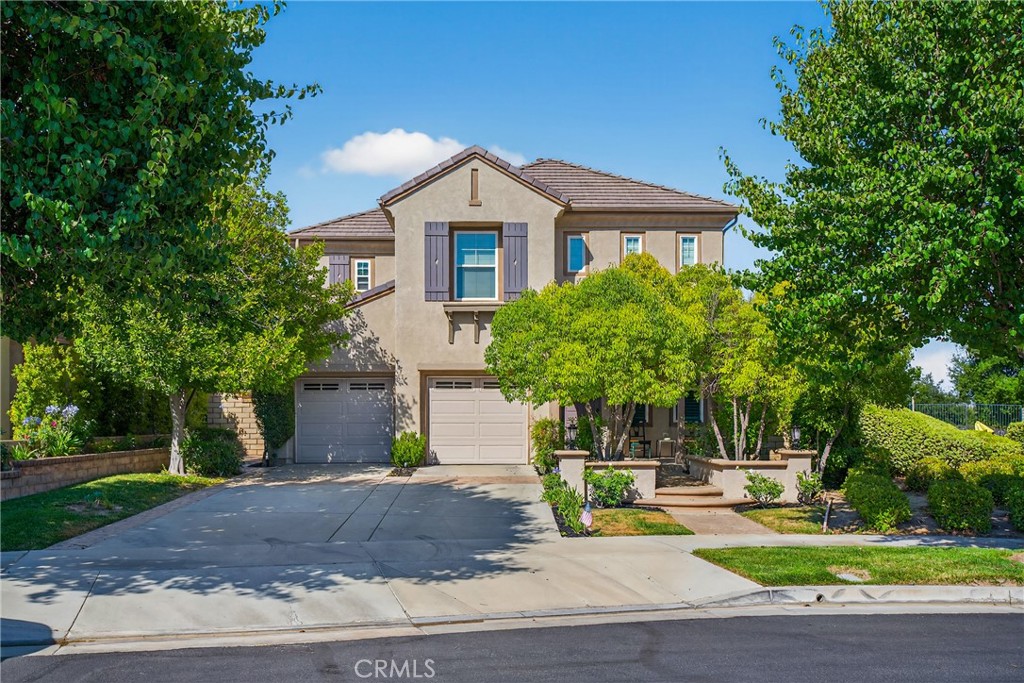 THIS IS THE ONE! Perched on a private, expansive lot in the coveted gated community of Westridge, this 5-bedroom, 3-bathroom home is more than a residence—it’s a foundation for imagination, connection, and timeless California living.
From the moment you arrive, a sense of warmth and welcome surrounds you. Set back beneath mature trees with undeniable curb appeal, the home invites you in with a cozy front porch designed for both style and function.
Inside, soaring cathedral ceilings and rich wood floors create a grand first impression, while plantation shutters lend a touch of classic sophistication throughout. The heart of the home is an airy white kitchen—timeless in design and open by intention—flowing seamlessly into a charming breakfast nook and relaxed family room with gas fireplace. This open-concept layout is made for gathering, entertaining, and everyday moments alike.
Glass doors invite you to step into your backyard sanctuary, where panoramic views of Santa Clarita stretch endlessly before you. By day, it's a peaceful retreat; by night, a front-row seat to twinkling city lights. With ample space for a future pool, a play area for kids, and room for pets to roam, the possibilities here are as limitless as your vision.
The thoughtful floorplan includes a full bedroom and bath downstairs—ideal for multi-gen living, overnight guests, or a tucked-away home office. Upstairs, four more spacious bedrooms await, including a serene primary retreat with sitting area offering city views and spa inspired ensuite highlighted by its soaking tub and dual-vanities. A split bedroom floorplan offers just enough separation between the primary and secondary bedrooms and a dual-vanity hall bath designed with both beauty and functionality in mind.
Life in Westridge is a lifestyle all its own—gated, private, and rich with resort-level amenities including two pools, tennis courts, sports courts, a clubhouse, and future pickleball courts—plus access to some of the most sought-after schools in the region. LOW HOA and NO MELLO ROOS!
Plan your private tour today!