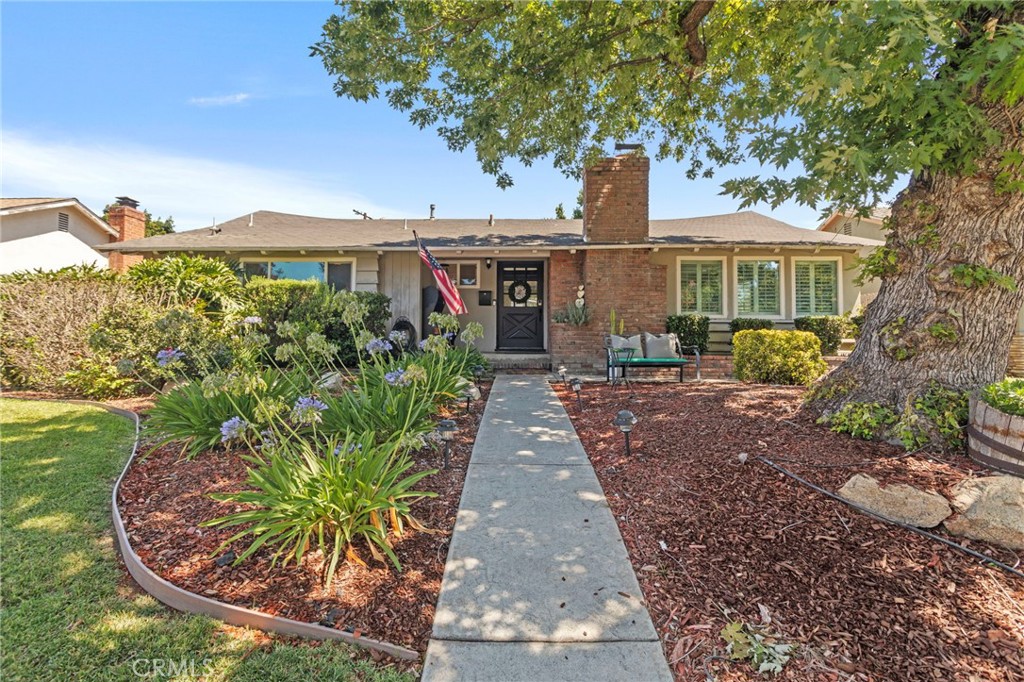 Welcome to this beautifully designed single-story residence, perfectly blending comfort, character, and functionality. From the moment you step through the front door, you are greeted by an inviting living room filled with natural light, highlighted by recessed lighting, elegant shutter blinds for privacy, and a cozy fireplace—the perfect setting for both special occasions and quiet evenings.
The open floorplan seamlessly connects the living area to the spacious kitchen and dining area, creating a true heart-of-the-home experience. The kitchen boasts ample cabinetry for storage, a peninsula with a stovetop facing the living room, granite countertops, and a center island, all designed for effortless entertaining. Just off the kitchen, a versatile fourth bedroom—perfect as a nursery or home office—offers direct access to the backyard patio through stunning sliding glass double doors.
Down the hall, you’ll find three additional bedrooms, including the enormous primary suite with a private retreat, an updated ensuite bathroom with modern finishes, and a generous walk-in closet. Throughout the home, crown molding, rich brown ceiling beams with ceiling fans to match add warmth and character, elevating every room.
Step outside to your private backyard oasis where a sparkling in-ground pool invites you to cool off or lounge poolside. Two mature Meyer lemon trees add a delightful touch, providing homegrown fruit and shade. The detached two-car garage has been fully finished with drywall, recessed lighting, and built-in racks, offering exceptional storage. Covered rear-facing parking and a spacious side yard—ideal for a dog run or additional storage—complete this versatile outdoor space.
Located near parks, shopping, dining, and local amenities, this home is also just moments from the prestigious Lincoln Park Historical District, where century-old homes showcase timeless architecture. As you explore the neighborhood, you’ll often see dozens of graceful peacocks roaming freely, adding a unique touch of beauty, elegance, and charm to this exceptional community—a truly enchanting place to call home.