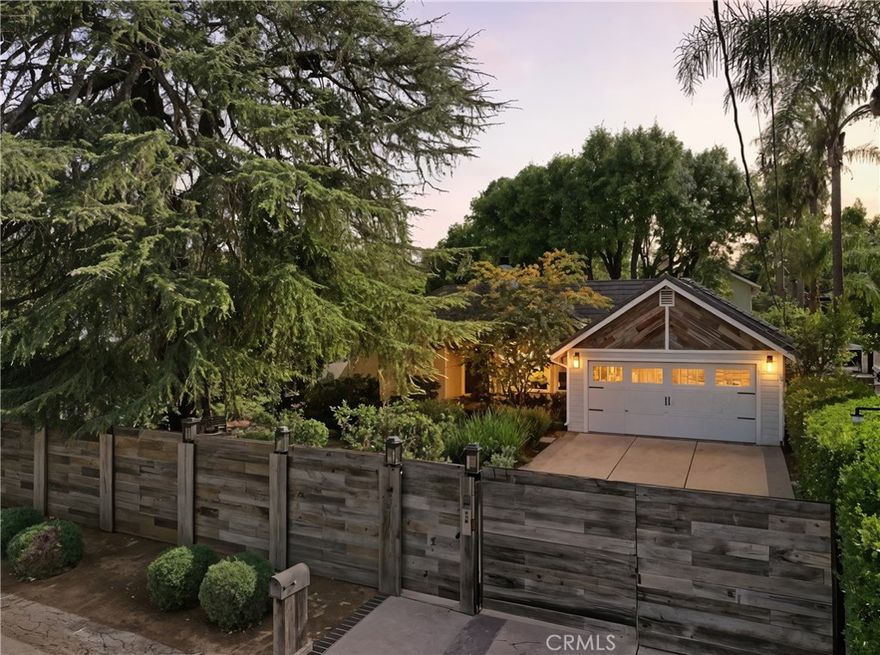 A One-of-a-Kind Walnut Acres Estate. Where Bespoke Design Meets California Living. Tucked in the highly coveted Walnut Acres of Woodland Hills—within one of the Valley’s best school districts—this extraordinary 3,866 sq fsq 4-bedroom, 5-bathroom residence is anything but cookie-cutter. Set on over a quarter-acre lot, the home offers a true backyard sanctuary, complete with award-winning, drought-tolerant landscaping, drip irrigation, and mature fruit trees including orange, pomegranate, lemon, and avocado. At the heart of the home, a stunning center open air courtyard built around a mature ash tree fills the interiors with natural light, creating a seamless connection between indoor and outdoor living. Every corner of the home reflects meticulous craftsmanship and refined design, from Restoration Hardware vanities to custom millwork and designer finishes throughout. All four bedrooms are ensuite, with the primary retreat featuring a steam shower, freestanding tub, and a hidden ceiling-mounted TV. The chef’s kitchen is a culinary masterpiece, equipped with top-of-the-line appliances, a custom pantry, and thoughtful designer details—perfect for both everyday living and entertaining. Entertain with ease in the custom game room and bar, complete with pool and ping pong tables, or step outside to the remastered pool, Trex deck, and fire pit under the stars. A detached art studio with a private garden offers a versatile space for creativity or relaxation, with potential for a 1,200 sq ft ADU (buyer to verify). Sustainability meets sophistication with an EV-ready garage and paid-off solar panels. This Walnut Acres estate isn’t just built—it’s crafted. Every room is a canvas, every detail a brushstroke. Experience the perfect blend of modern elegance, comfort, and functionality in one of Woodland Hills’ most desirable neighborhoods. Welcome to a home where California living is elevated to an art form.
