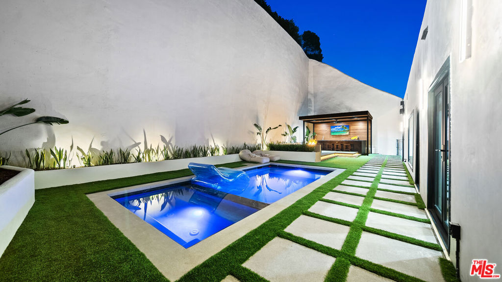 Fully furnished and turnkey for short, mid-term and long-term rental! Enter this newly remodeled, pedestrian-gated, Beverly Hills Post Office 5bd modern masterpiece! Entertain and enjoy family and friends in the open spaces, high ceilings and a ton of natural light highlighting this approximate 4,000sf, five bedroom, five bath home for lease in BHPO. Enjoy the oversized living room with bamboo floors, fireplace and adjacent patio with al fresco dining, as well as the center island chef's kitchen with top-of-the-line stainless steel appliances, walk in pantry, double sinks and granite countertops. Upstairs you will find three en-suite bedrooms including the large primary suite which is complimented by a second fireplace and balcony. Two additional bedrooms and a bathroom are located on the lower level which has access from the main house or can be locked off and entered through its own private entrance. The area also includes a separate living room with pool table, additional kitchen, living room, and an additional which is considered an attached guest house. The house is complete with a private backyard and two car garage in a serene setting adjacent to Franklin Canyon Park which offers a serene lake and beautiful hiking trails; minutes to all the action in Beverly Hills.