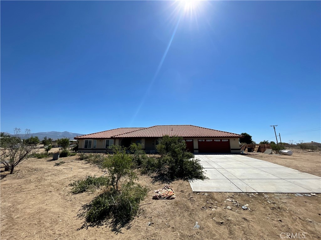 This beautifully updated 4-bedroom, 2-bathroom home offers over 2,300 sq ft of comfortable living space, all on a sprawling gated lot with breathtaking views. The open floor plan features high ceilings, fresh paint, and brand-new laminate wood flooring throughout. Enjoy a large kitchen with a breakfast bar and a walk-in pantry—perfect for entertaining or daily living.The expansive den provides flexible space that can serve as a home office, game room, fitness area, or whatever your lifestyle needs. The oversized primary suite includes a walk-in closet, a soaking tub, and a separate shower for a luxurious retreat.Outside, the property boasts a variety of fruit trees, a spacious yard, and a charming front porch with panoramic views. A rare opportunity to enjoy privacy, space, and beauty—all in one place.