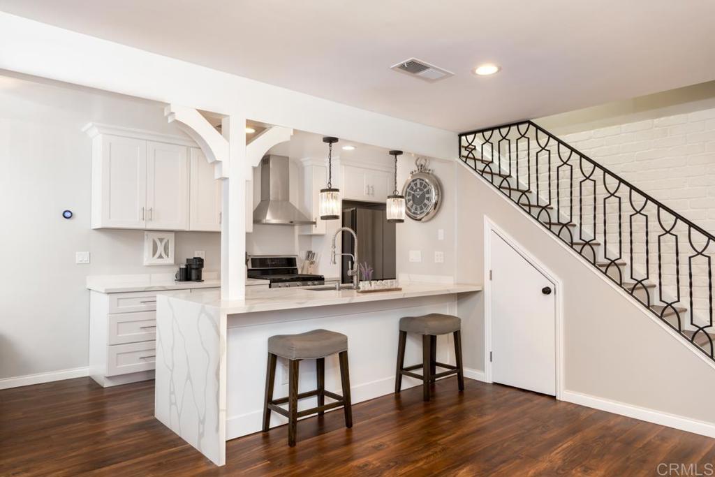 Beautiful move in ready condo, featuring chef's kitchen with stainless steel sink and appliances, sleek quartz counter tops with breakfast bar and waterfall edge, soft close shaker style cabinets and decorative overhead pendant lamps. Luxurious bathroom with carrera white marble floors and counters, oversized bath tub and dual vanities. Spacious master bedroom with walk in closet. One car garage and one assigned driveway space with plenty of street parking for your guests. Kitchen pantry has laundry hookups for optional stacked washer/dryer in unit. Luxury wood finish vinyl plank flooring in common areas. Newer vinyl dual pane windows. Central heating and A/C with Nest smart thermostat along with Ring doorbell. Recessed LED lighting throughout home and crystal chandelier in dining area.