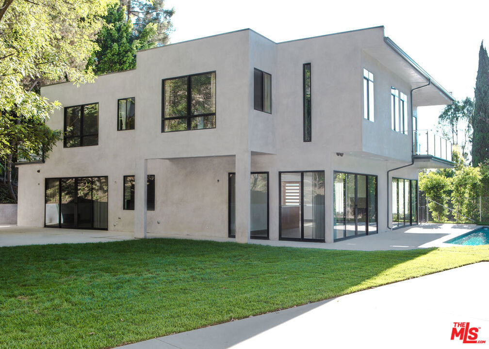 Striking newer construction of elegant contemporary design. Walls of glass sliding doors lead out to a sparkling pool from the huge open plan living room, ideal for entertaining and family gatherings. Open plan kitchen with sliding glass doors leading to the large side garden and outdoor BBQ built in area. 4 bedrooms suites upstairs, the master with a balcony looking out to the pool. A stunning bright luxurious home. Ideal location , easy access to the studios, a few minutes from trendy restaurants/shops on Ventura blvd, Fryman Canyon hike in the hills, and over the hill a short drive to the heart of Sunset blvd and Hollywood night life. Resort style living in the city. Pictures were taken before landscaping was complete.