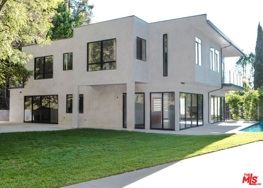 Striking newer construction of elegant contemporary design. Walls of glass sliding doors lead out to a sparkling pool from the huge open plan living room, ideal for entertaining and family gatherings. Open plan kitchen with sliding glass doors leading to the large side garden and outdoor BBQ built in area. 4 bedrooms suites upstairs, the master with a balcony looking out to the pool. A stunning bright luxurious home. Ideal location , easy access to the studios, a few minutes from trendy restaurants/shops on Ventura blvd, Fryman Canyon hike in the hills, and over the hill a short drive to the heart of Sunset blvd and Hollywood night life. Resort style living in the city. Pictures were taken before landscaping was complete.
