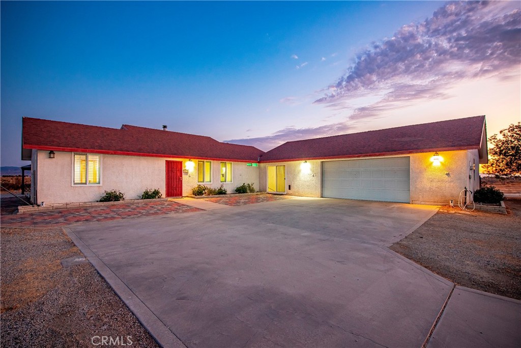 Come and enjoy the open skies and rural living with this custom-built home on 2.5 acres! This 2 bedroom + bonus room and 2 bathroom home features carpet and tile flooring, ceiling fans, and plantation shutters throughout. The wood-burning stove centers the spacious living room and has a stone wall and hearth that creates a walk-around entrance to the kitchen. The kitchen is designed with multiple custom Oak cabinets, custom tile
countertops and backsplash, and appliances which include a freestanding microwave and refrigerator. The additional cabinets offer a buffet-style countertop, which is perfect for entertaining, and is conveniently located off the dining area in the kitchen. The bedrooms are spacious, with the primary room offering a walk-in closet. The primary bathroom features dual vanity sinks and a large walk-in shower, whereas the guest bathroom includes a single sink vanity and tub/shower enclosure. There is an additional bonus room without a closet, but it can be converted to a bedroom. The enclosed bonus area/breezeway is great for additional storage or a hobby room. It also leads to the indoor laundry room, which has cabinets and a sink. The attached oversized two-car garage offers plenty of work space and hanging shelves. Step outside and bring your creative ideas as you have a clean slate to create your paradise! Key features to consider include a newer roof, a freestanding pergola with a concrete slab, chain link fencing, and a concrete driveway. The home to the north is also listed (4636 E. Avenue H) and can be used for multi-family living if desired.. A cross fence exists separating both properties with a portion of the fencing removed for access. The missing fencing will be replaced if the homes are sold separately. Bring your livestock, toys and your family and enjoy country living at its best!