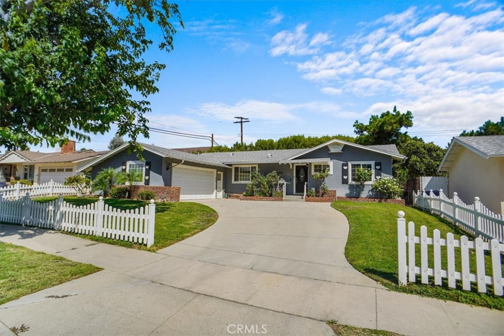 This charming 3-bedroom, 2-bathroom home features stunning curb appeal with a manicured lawn and a classic white picket fence, and has been meticulously cared for by the same family for over 40 years. Spanning 1,349 sq ft on a spacious 7,776 sq ft lot, the residence includes a nice sized family room with Fireplace and a separate den with a closet, offering potential as a fourth bedroom. The backyard provides privacy with drought-resistant landscaping and a full covered patio, perfect for enjoying the outdoors. Additional amenities include a spacious attached 2-car garage with direct access and an inside laundry room off the kitchen. Located on a beautifully maintained street, this home is centrally situated with easy access to both the 118 and 101 freeways, making commuting throughout the valley convenient. Don't miss the opportunity to own this well-preserved gem in the valley.