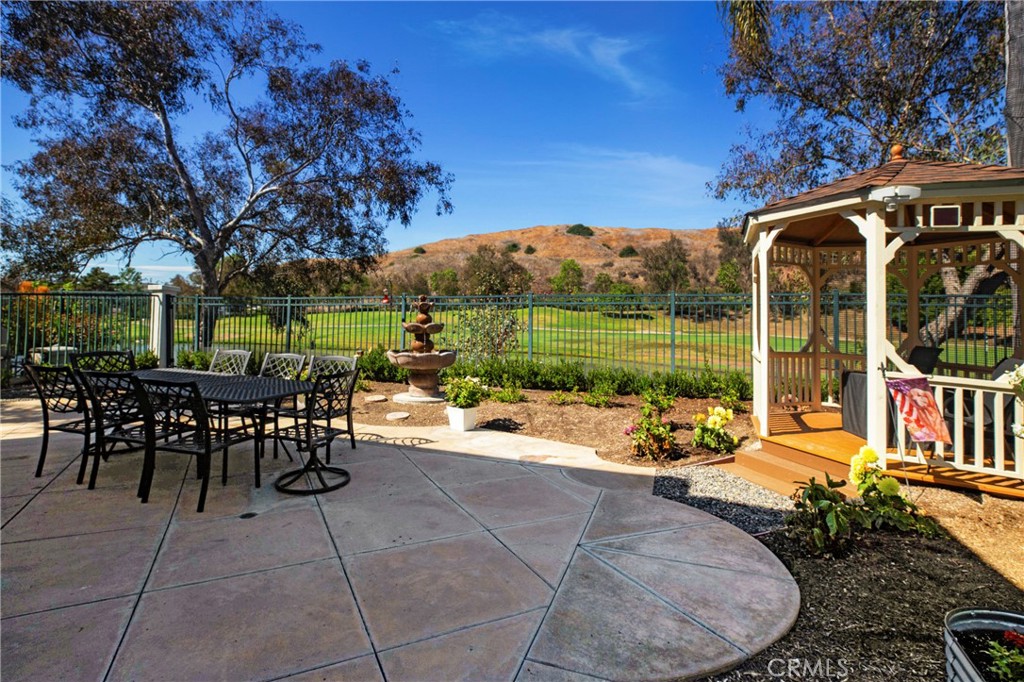 Welcome to this stunning 3-bedroom plus office, 3-bathroom home nestled in the gorgeous gated community of San Juan Hills. With one of the best lots in the community this home has lake, golf course and hills views. The open-concept floor plan is bathed in natural light, creating a warm and inviting atmosphere throughout. The spacious kitchen features an oversized island with soft close drawers, a walk-in pantry, and abundant storage, making it perfect for both everyday living and entertaining. It seamlessly flows into the cozy family room, complete with a gas fireplace and built-in shelving. Formal dining room has custom wine rack and there is also a custom wrought iron staircase to take you upstairs. Upstairs, you'll find three well-appointed bedrooms, plus a versatile loft area. The primary suite is a peaceful retreat, offering a private Juliette balcony that overlooks the tranquil outdoor space. Step outside to a serene patio and beautifully landscaped garden with fountain and gazebo overlooking the golf course and lake ideal for relaxing or hosting al fresco dinners with plenty of space for guests. This home effortlessly combines comfort, style, and functionality, making it an ideal place to call your own. This home is centrally located to dining, shopping and freeway close, minutes to the beach and offers an array of recreational activities including hiking in the beautiful surrounding hills. This home is a must see.