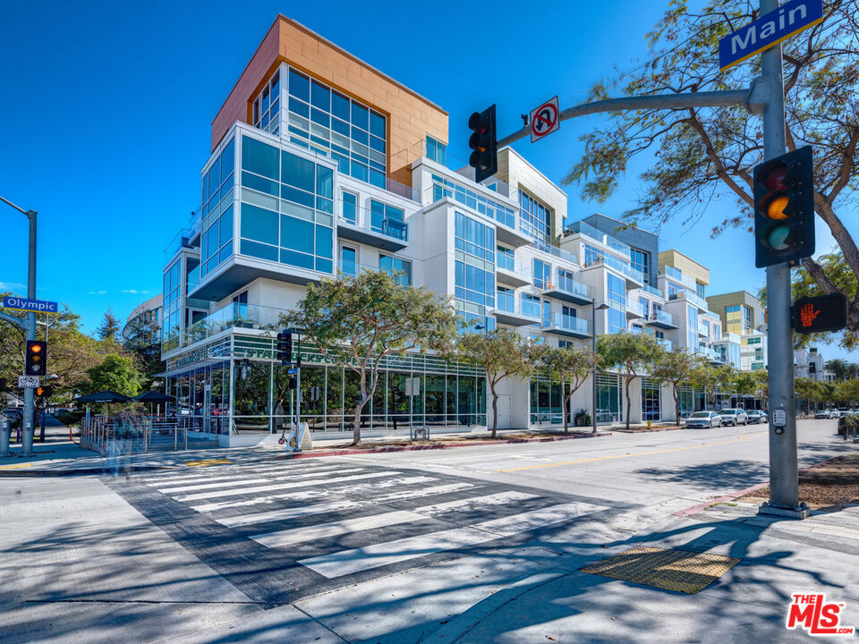 Experience the epitome of coastal luxury living at The Waverly on Ocean Avenue, one of Santa Monica's most sought-after new condominium offerings. An unbelievable value, this stunning model residence spans two levels and features two bedrooms and two bathrooms, all impeccably designed by world-renowned Marmol Radziner. Soaring double-height UV-reflective windows with motorized shades fill the home with natural light while offering serene views of Tongva Park.The open-concept living space boasts 14-foot ceilings, wide-plank hardwood floors, and a chef's kitchen outfitted with Thermador stainless steel appliances, Sea Pearl quartzite countertops, and custom oak cabinetry. Upstairs, the private primary suite is a true retreat, complete with a walk-in closet and a spa-inspired bathroom featuring a dual vanity, soaking tub, and glass-enclosed shower.Additional highlights include an in-unit washer and dryer, dedicated storage (including separate bike and surfboard storage), and side-by-side parking for two vehicles. Residents of The Waverly enjoy a wealth of five-star amenities: a 24-hour doorman/concierge, security services, fitness center, pet spa, and exclusive access to the Skybridge Lounge a fifth-floor sanctuary with a full kitchen, fireplace, barbecue, private patio, and sweeping ocean views. Perfectly situated just steps from the beach and moments from Santa Monica's premier shopping, dining, and entertainment, this residence truly offers it all.