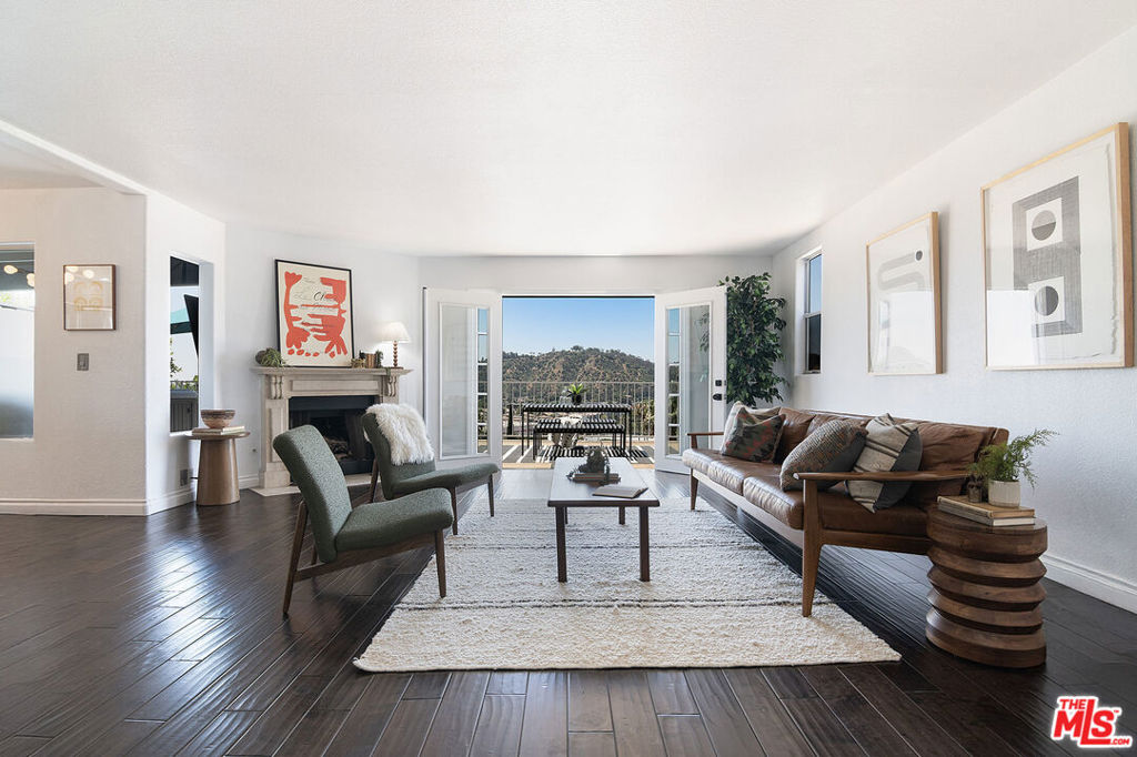 Set in the lush, sun-soaked hills of Mt. Washington, this airy, well-proportioned home captures the laid-back sophistication that defines LA living. Updated with intention and an eye for ease, comfort, and beauty, it's a place where style and setting come together with quiet confidence. With 3 bedrooms, 2.5 baths, and three separate decks on different levels, the expansive views invite you to move with the light, the breeze, and the moment. The main living area opens to an expansive deck with a hot tub and panoramic views that reach all the way to Dodger Stadium. Inside, two fireplaces - one anchoring the living room, the other warming the primary suite, add a layer of warmth and quiet drama; serene by day, and just a little bit cinematic by night. Upstairs, the primary suite offers a true sense of retreat. A built-in window seat frames the city like a painting, while just beyond, a spacious covered patio becomes the home's most unexpected and enchanting room. Effortlessly connected to its surroundings, this Mt. Washington home is a rare find: quietly stylish, deeply comfortable, and a place that doesn't just fit your life - it elevates it.