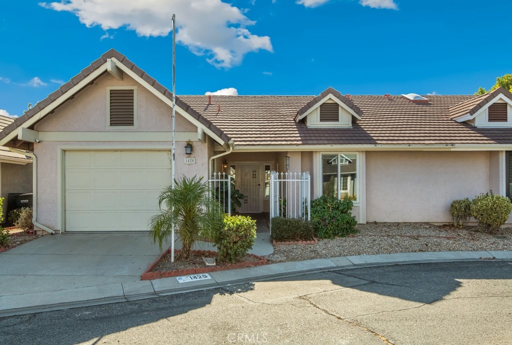 Welcome to American Village- The beautiful, affordable 55+ Community in San Jacinto. This nicely updated Condo sits on a cul de sac with friendly Neighbors and it showcases 2 Bedrooms with 2 Bathrooms and 1,126SF. This is the perfect place to call home! You will love the OPEN LAYOUT- with the Living Room, Dining Room, and Kitchen being 1 open space. The entire Condo was recently painted, there is a cozy fireplace, and lovely dark wood floors throughout. There are skylights in both Bathrooms, offering plenty of natural light. Enjoy the updated Kitchen with light gray cabinets and granite counters. There is even a dining area for your enjoyment! The 2 Bedrooms are on opposite ends of the home for privacy and both include spacious closets. What’s UNIQUE about this place is the gate that gives access to the back patio, providing an additional exit should there be an emergency. Not many homes in this community have that!
