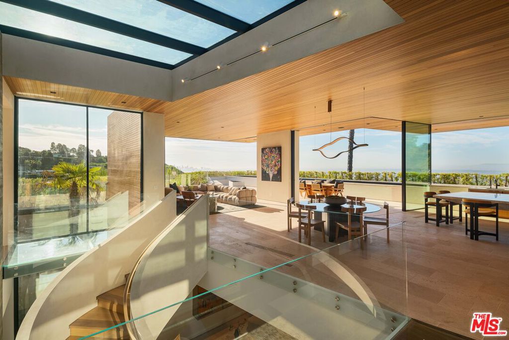 Acclaimed Noah Walker architectural in Beverly Hills. A true masterpiece of modern design surrounded by nature while perfectly integrating luxury with tranquility. Set against the backdrop of the coveted Trousdale Estates, the residence offers head on city views of the Los Angeles skyline and ocean views of the Pacific. This immaculate home features expansive open-concept living spaces and floor-to-ceiling windows flooding the interiors with ample natural light and creates a seamless indoor-outdoor flow. Beautiful minimalist design, warm finishes and thoughtfully curated materials effortlessly blend throughout the home. Only a few in Trousdale are this polished for the most discerning.