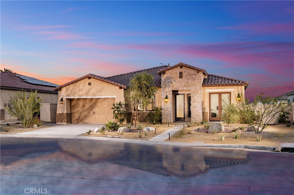 Stunning Single-Story Desert Oasis located in the beautiful gated Palo Verde community in La Quinta. This 4 bedroom, 3.5-bath residence offers modern luxury, breathtaking mountain views, extensive upgrades throughout & a perfect location near PGA West and Empire Polo Club. Amazing 20 foot multi-slide doors lead to your private covered retreat with a large custom pebble tec saltwater pool and raised spa crafted by Teserra, complete with a waterfall and custom glass tile accents. Entertain in style on the Trex pool deck, relax in the shaded California room or keep cool with the built-in misting system. A large side yard with turf provides space for gardening, pets, or future projects. The open-concept floor plan centers around a quartzite island kitchen with premium Café stainless steel appliances and a built-in refrigerator. Seamless indoor-outdoor living make this home perfect for both relaxation and entertaining. Smart and sustainable features include a FULLY OWNED solar system, smart home technology for remote control and convenience, custom woodwork throughout, including wainscotting & custom barn doors, and an epoxy-coated 3-car garage. With a proven rental history, this home is equally ideal as a primary residence, vacation escape, or income-producing investment property. Don’t miss this chance to own your slice of paradise in the heart of La Quinta’s most coveted luxury community near PGA West and Madison & 58th street.