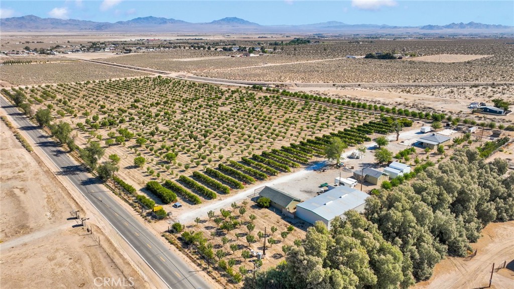Organic Orchard Estate – 19.5 Acres of Fully Operational Farmland with Residence, ADU, Equipment, and More
A rare and fruitful opportunity to acquire 19.5 acres of productive, organic farmland, lovingly cultivated and maintained by the same owner for over 20 years. This thriving orchard is home to over 2,000 mature fruit trees, producing a wide variety of high-demand fruits and offering immediate income potential. Fruit varieties include four types of apples—Fuji, Pink Lady, Honeycrisp, and Gala—along with red and yellow Bartlett pears. There are also several varieties of peaches, including white, yellow, and freestone. Additional crops include jujube, pomegranates, almonds, Santa Rosa and Burgundy plums, Thompson Seedless and Champagne grapes, Green Gage grapes, and seasonal melons. The diverse mix supports a long and productive harvest season, attracting both wholesale buyers and retail customers. This is a full agricultural business and includes all the equipment necessary for farming, harvesting, and processing. Included in the sale are a tractor, box truck, fruit bins, nutrient sprayer, industrial fruit juicer, fruit and vegetable washer/sorter, drying tables, and more. Everything is in place to continue operations without interruption. The main residence is a well-maintained 2-bedroom, 2-bathroom home offering approximately 1,300 square feet of living space. It includes central HVAC and an evaporative cooler to ensure comfort year-round. A separate 2-bedroom, 1-bath accessory dwelling unit (ADU) provides ideal accommodations for a farmhand, guest quarters, or potential rental income. An 80-by-40-foot metal shop building houses a 20-by-40-foot walk-in commercial refrigerator, offering ample cold storage for harvested produce. The property also features a detached garage for tools and equipment and a dedicated on-site fruit stand, making it easy to sell directly to the public. Water is supplied by a private well that has been expertly maintained by one of the most reputable well service companies in the area. Complete maintenance records and documentation are available upon request. Whether you are an experienced grower, an investor seeking a high-yield agricultural asset, or someone looking to embrace a self-sustaining lifestyle, this unique property offers long-term value, immediate revenue potential, and the satisfaction of owning a fully operational organic farm. Schedule your tour today and see all that this orchard estate has to offer.
