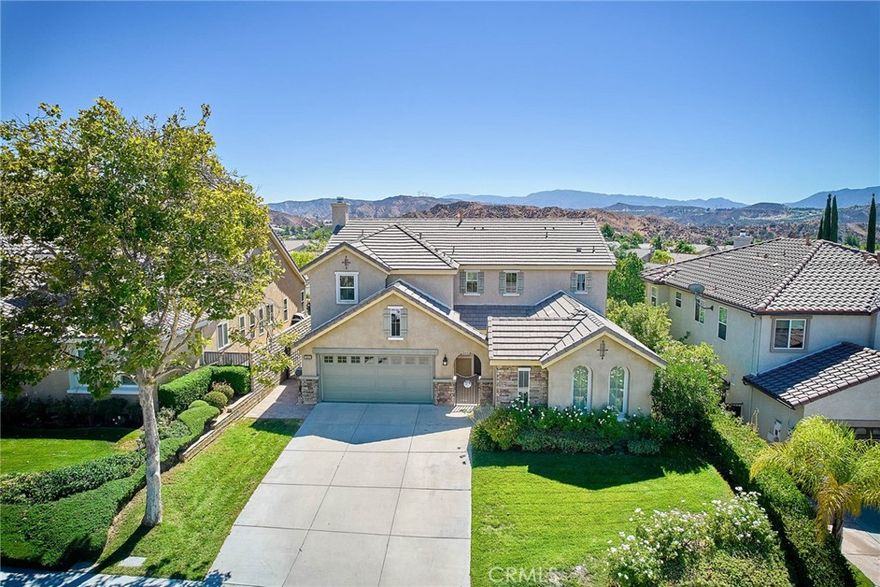 SUPER CLEAN. Stunning 4 Bedroom+1 Loft, with Mountain Views & Exceptional Layout. Welcome to your dream home in the esteemed Estrella Vista community of Santa Clarita! This meticulously maintained 3,011 sq. ft. residence is situated just north of Copperhill Drive in one of the most peaceful, safe, and sought-after neighborhoods. Built in 2002, this gem of a home offers an incredibly attractive and functional floor plan. Enjoy engineered hardwood floors in common areas, new carpeting in all bedrooms, and custom paint and molding throughout—including crown molding in the living room and dining room, window casings and chair rail details, and upgraded bathroom faucets.



The gated front entry offers enhanced security and an enclosed private space. As you enter the home, you’ll be greeted by high ceilings, a beautiful staircase, and a spacious tiled foyer. Adjacent to the grand entry, there is a formal living and dining area, with lots of windows for abundant natural light. The kitchen, featuring upgraded appliances and an island with a breakfast bar for two, flows seamlessly into the bright family dining area and family room —complete with a clean fireplace and splendid mountain views. The main level also includes one bedroom, one full bathroom, and a laundry room with a utility sink. Storage space is plentiful throughout the home, including a walk-in storage under the staircase and custom built-in cabinets in the family room and garage entry.



Upstairs, you’ll find some of the largest secondary bedrooms in the neighborhood, plus a massive loft with cabinetry—ideal as a media room, play area, or home office. The upstairs A/C was upgraded just four years ago! The primary suite is a must-see, enhanced with a private sitting area and a custom built-in closet in addition to a big walk-in closet. Outside, mature trees, paver stones, and beautifully framed mountain vistas create a serene backdrop for entertaining or relaxing. There is no swimming pool or backyard lawn, so low maintenance landscaping will save water and electricity costs significantly.



Just minutes away from scenic parks! With a 3-car garage, no Mello-Roos, low HOA, and close proximity to Copperhill Drive for easy access to shopping, dining, and commuting, this residence checks every box. Don’t miss this rare opportunity to own a move-in ready home in one of Santa Clarita’s most coveted neighborhoods. Schedule your private tour today!