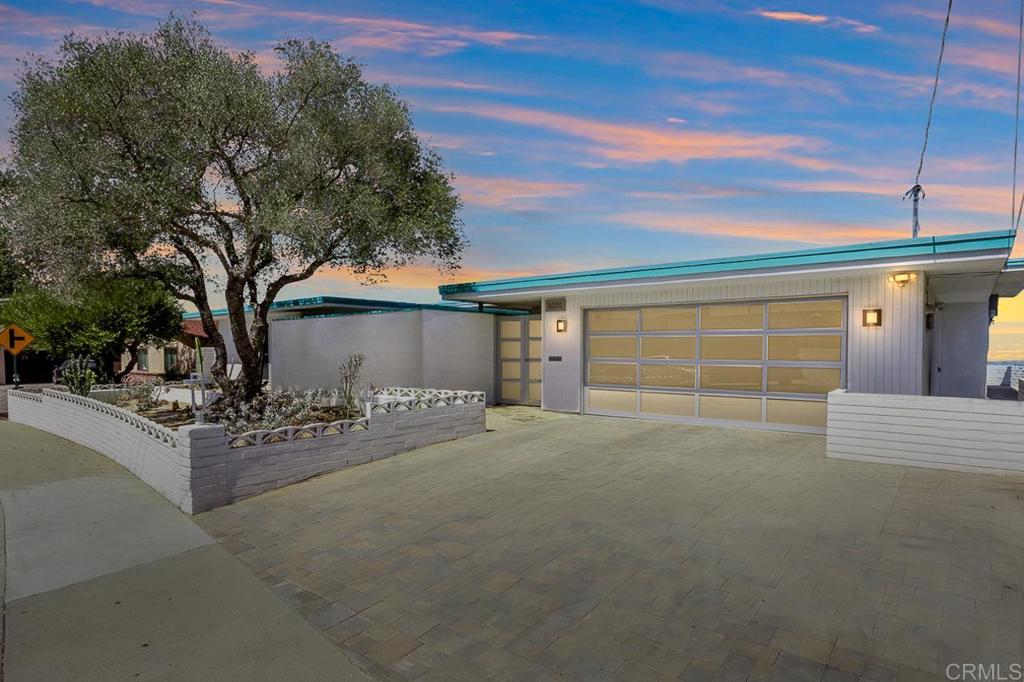 Perched atop a scenic hill in La Mesa, this stunning single-level home offers unobstructed sweeping panoramic views of San Diego — from rolling hills to sparkling coastline sunsets! Thoughtfully remodeled and move-in ready, this 3-bedroom, 3-bath gem combines contemporary upgrades with effortless indoor-outdoor living. Step inside to an expansive open floor plan flooded with natural light, perfect for entertaining or simply enjoying the breathtaking views. The fully remodeled kitchen, featuring a large island, granite countertops, sleek cabinetry, and integrated refrigerator and freezer for a seamless modern look. The spacious primary suite is a true retreat with its spa-inspired en suite bathroom, highlighted by a soaking tub, dual vanities, and serene finishes. A second en suite bedroom provides privacy and comfort for guests or multigenerational living. The permitted sunroom offers a peaceful space to relax, dine, or work — all while soaking in unobstructed views stretching from the city skyline to the Pacific Ocean. Outside, the landscaped front yard is equipped with a timed sprinkler and drip system, ensuring easy maintenance year-round. A full-size two-car garage adds convenience and storage. Don’t miss this rare opportunity to own a beautifully upgraded home with unmatched views in one of East County’s most desirable neighborhoods!
