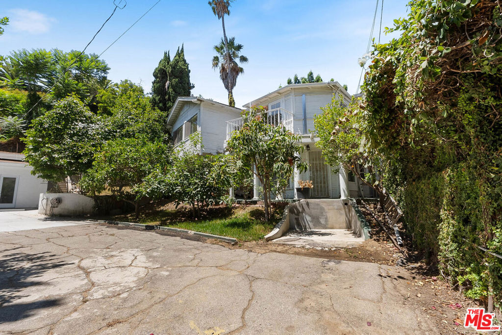 Set on a private flag lot, peacefully tucked away from Glendale Boulevard, 823 Glendale Blvd offers rare seclusion and privacy just steps from the energy of Echo Park Lake. This income-producing compound includes a classic 1920s up/down duplex with new plumbing, electrical, sewer, and HVAC (heating + AC) systems, plus a newly built, detached solar-powered ADU with vaulted ceilings and private access. Fully owned solar panels service both the main residence and the ADU. All three units are delivered vacant, offering a blank slate for owner-users, investors, or 1031 exchange buyers looking to maximize rental income from day one. The existing layout is functional and income-ready as-is, with the upstairs unit offering the potential to be reconfigured into a true 3-bed, 2-bath, unlocking meaningful upside. The gated lot includes mature fruit trees and multiple private outdoor spaces, creating a quiet, garden-like setting rarely found this close to the lake. The ADU is fully permitted and turnkey, designed with privacy and efficiency in mind, and perfect for extended family, long-term tenants, or creative use. This is a rare opportunity to own a flexible, fully vacant triplex in one of LA's most iconic neighborhoods with upgraded systems, future potential, and a setting that feels like a hidden retreat in the heart of the city.