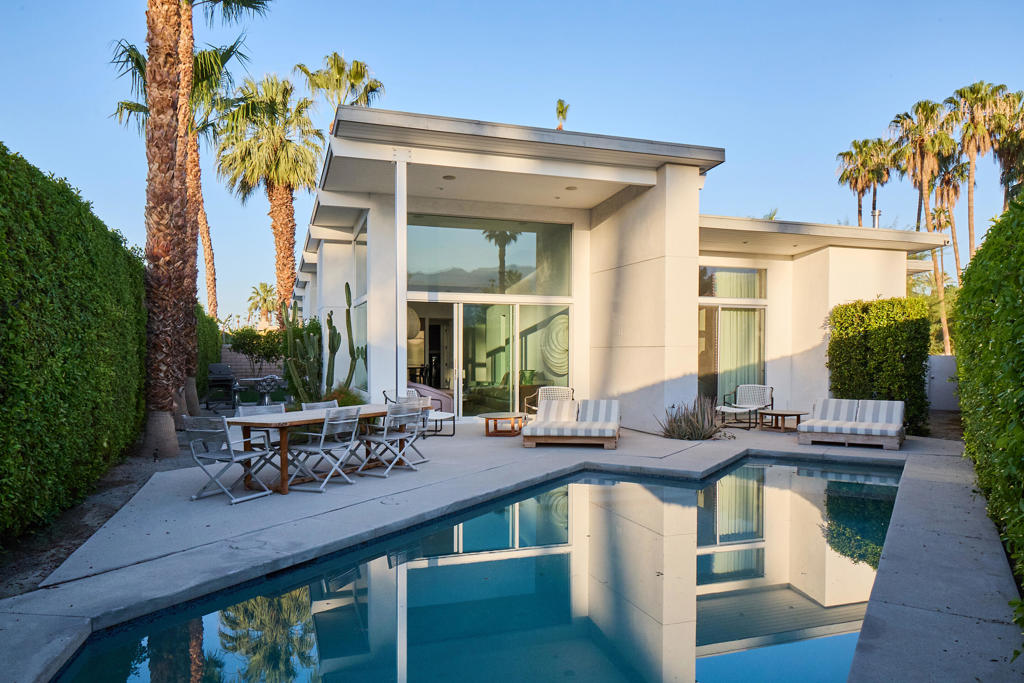 Located in the historic Tamarisk neighborhood of Rancho Mirage, just steps from the pedestrian gate to Tamarisk Country Club, on a secluded circle, this newer construction modern home offers the refinement and privacy of Tamarisk's greater estates. The was reimagined by renowned interior designer Darren Brown, who also created the interiors at the nearby Ford Estate. Butterfly roofline that vaults upward toward the mountain for optimal views. Built in 2017 and remodeled in 2023. Originally three bedrooms, it now boasts two ample bedroom suites each with walk in closets, and a serene and well designed den for TV and lounging. The main living space is incredible, and flows directly from living room and primary suite to the large private pool and spa, hedged and walled for maximum privacy. Perfect for those seeking a smaller footprint in their favorite neighborhood without sacrificing the privacy of a single family home, or the elegance found at the multi million dollar price points. This opportunity is rare. No HOA. Call today for a private showing.