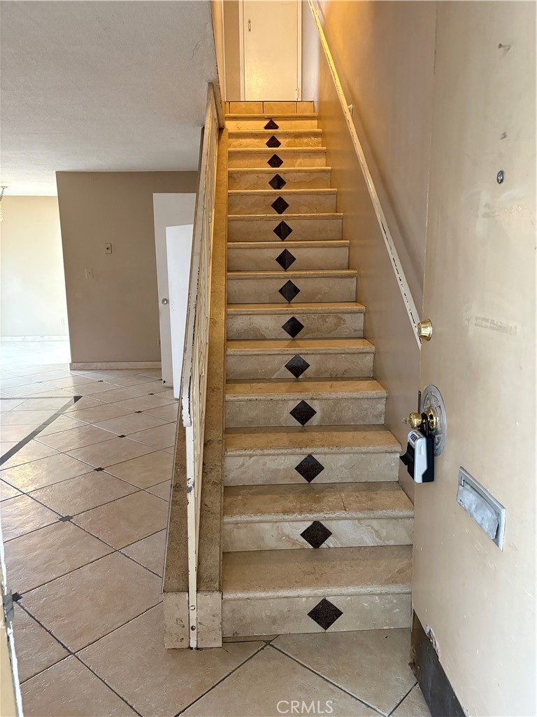 Tustin Village is now a gated community (gates added in 2025). This is a beautiful townhouse with large bedrooms, large living room/dining area, and large private covered patio. The unit has brand new dual-pane low-E, vinyl windows, making for a very quiet and peaceful interior space. There are custom limestone/granite stairs, and quality tile (see pics) in Living Room. The kitchen cabinets are made of very good quality wood. No particle board here. There is one dedicated carport and the unit can have a permit for parking a second car inside the gates. This community is one of very few with substantial "rainy day" financial reserves in the bank. I believe it totals about $600,000.