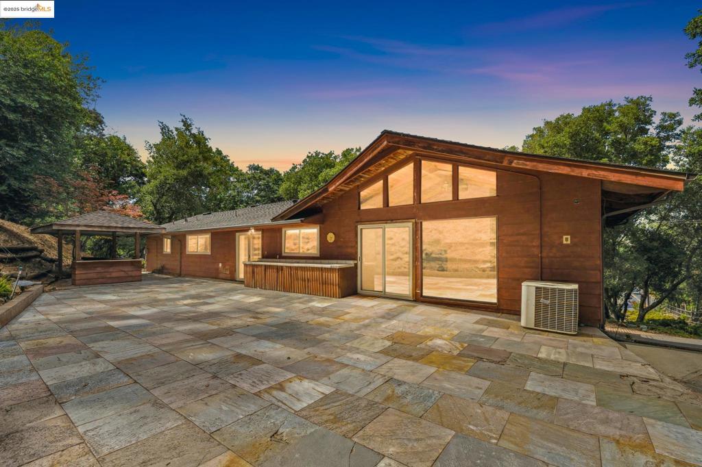 Discover a Hidden Gem nestled in the scenic Alhambra Valley of Martinez! This one-of-a-kind property offers the perfect blend of rustic charm, seclusion, and untapped potential. The midcentury modern home features 3 spacious bedrooms, 3 bathrooms, and over 2,099 sq ft of living space and includes a bonus entertainment room (approx. 710 sq ft) on the lower level—ideal for gatherings, game nights, or a cozy media lounge. The bonus room opens to the pool deck that is waiting to be reimagined. Set on 1.16 acres, the property is being sold with an adjacent .68-acre parcel—perfect for horse lovers, homesteaders, or anyone ready to bring their vision to life. While the home retains charm in its original condition, it awaits your creative touch, the setting is truly magical. Surrounded by mature trees, the home sits above the road, flanked by a Christmas Tree farm and backed by Briones Regional Park for unmatched privacy and a close connection to nature. And the standout feature? The iconic Two Bit Ranch Barn—a two-story structure known and loved by locals, instantly recognizable to anyone who’s driven through Alhambra Valley. It’s a unique centerpiece waiting to be restored or repurposed into something incredible. Turn this timeless ranch property into the estate of your dreams!