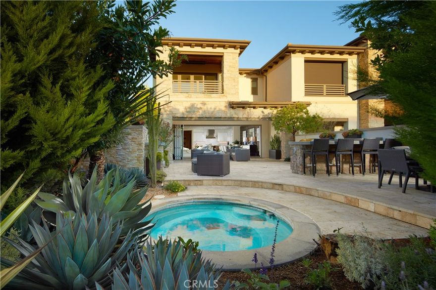 Resort living meets timeless coastal elegance behind the gates of Monarch Beach. This beautifully upgraded retreat offers three bedrooms, four-and one-half-bathrooms and approximately 3,325 square feet of refined interiors with high ceilings on both levels and seamless indoor–outdoor flow.



Sophisticated living space opens through disappearing sliding glass walls to a private entertainer’s backyard with built-in barbecue island, outdoor lounge areas and lush greenery. An ocean-view primary suite features a private terrace overlooking Catalina-lined sunsets, along with two oversized walk-in closets and a spa-inspired bathroom with soaking tub and large walk-in shower.



Every detail reflects thoughtful design—from fully automated window shades to integrated sound, elevator, custom lighting, and stone finishes throughout. A chef’s kitchen centers the home with an oversized island, Sub-Zero refrigeration, Wolf range, butler’s prep area and walk-in pantry, opening to the generous great room and dining lounge.



Positioned in a premier coastal enclave with lifestyle amenities at your doorstep—Waldorf Astoria Monarch Beach Resort & Club for daily spa access and ocean-view dining, Ritz-Carlton Laguna Niguel, Salt Creek Beach, Strands Beach, scenic coastal trails and Sea Terrace Park’s Concerts in the Park. Nearby Tennis & Pickleball Club at Monarch Beach adds to the active lifestyle appeal. Luxury, leisure and location align in this exceptional coastal home.