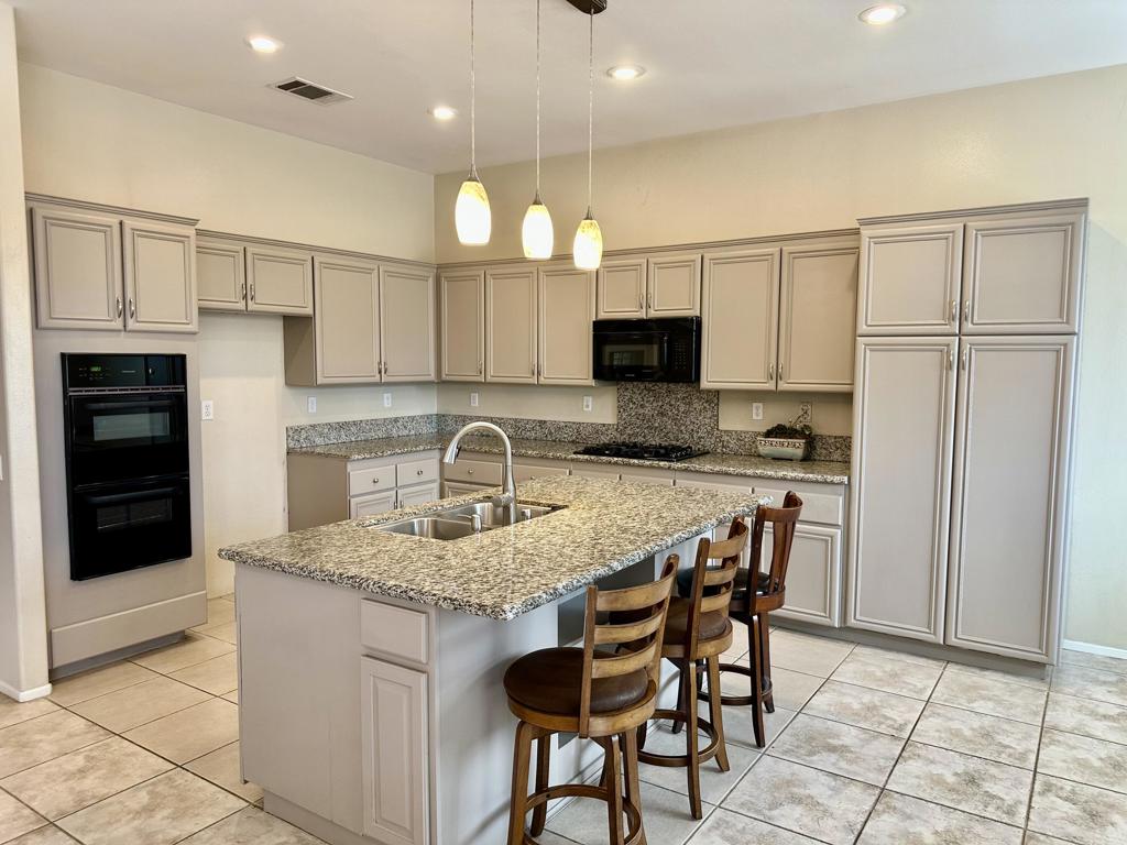 Welcome to La Quinta Del Rey -- a highly desirable community ideally located near premier shopping, dining, and entertainment!This beautifully maintained 3-bedroom, 2.5-bath home is perfect for couples or families seeking comfort, convenience, and access to top-rated schools. Inside, you'll find a thoughtfully designed floor plan featuring a private living room and a separate great room -- perfect for both everyday living and entertaining.The open-concept kitchen is an entertainer's dream, complete with granite countertops, abundant cabinet storage, an island with pendant lighting and built-in sink, a breakfast bar, and two built-in ovens. It flows seamlessly into the spacious family room, highlighted by a gas-burning fireplace with an elegant tile surround.Upgrades include stylish tile flooring throughout the kitchen, family room, and hallways, as well as plantation shutters and vertical blinds that enhance both privacy and style. The home also features a gated front courtyard, a double-door entry surrounded with low maintenance yard, and a two-car garage. A bonus converted garage space offers endless possibilities as a hobby room, home office, or additional living area.Step outside to your private desert oasis complete with a sparkling pool and spa, a spacious patio ideal for BBQs, a trellis-covered lounge area, and a storage shed. All of this is set against the breathtaking backdrop of the Chocolate Mountains. A must see!