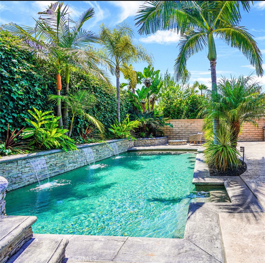 Stunning Single-Level Oasis with Resort-Style Backyard in Prime Location!! Escape to your own private paradise in this stunning single-level home, where a spectacular, professionally designed exotic landscape surrounds a magnificent pool and spa with sensational spillways. This exceptional residence offers the perfect fusion of seamless indoor-outdoor living, creating an entertainer's dream. Step through the welcoming entrance and be captivated by the home's effortless flow. The sunlit residence with upgradeds features culinary creators delight, with rich maple cabinets opening gracefully to a garden bar and a built-in barbeque island. At the touch of a button, a remote-controlled shade extends to create a cool, inviting space for alfresco dining. The luxurious primary suite serves as a sanctuary, offering picturesque views overlooking the beauty of the richly crafted pool oasis. The inviting living room, anchored by a cozy fireplace, provides a warm and welcoming atmosphere for relaxation. This beautiful home also includes two additional comfortably sized bedrooms and two full bathrooms, ensuring ample space for family and guests. Functionality and convenience are paramount, with a fully finished garage providing ample room for vehicles and storage. The huge side yard is thoughtfully designed with designated areas for trash concealment and pool equipment, keeping everything neatly organized and out of sight from the pristine yard. Don't miss this rare opportunity to own a piece of paradise. This exceptional property is a true gem, offering luxury, comfort, and unparalleled outdoor living. Additionally, you'll have exclusive membership privileges to Lake Mission Viejo, granting access to fishing, swimming, boating, and a range of lakeside activities.