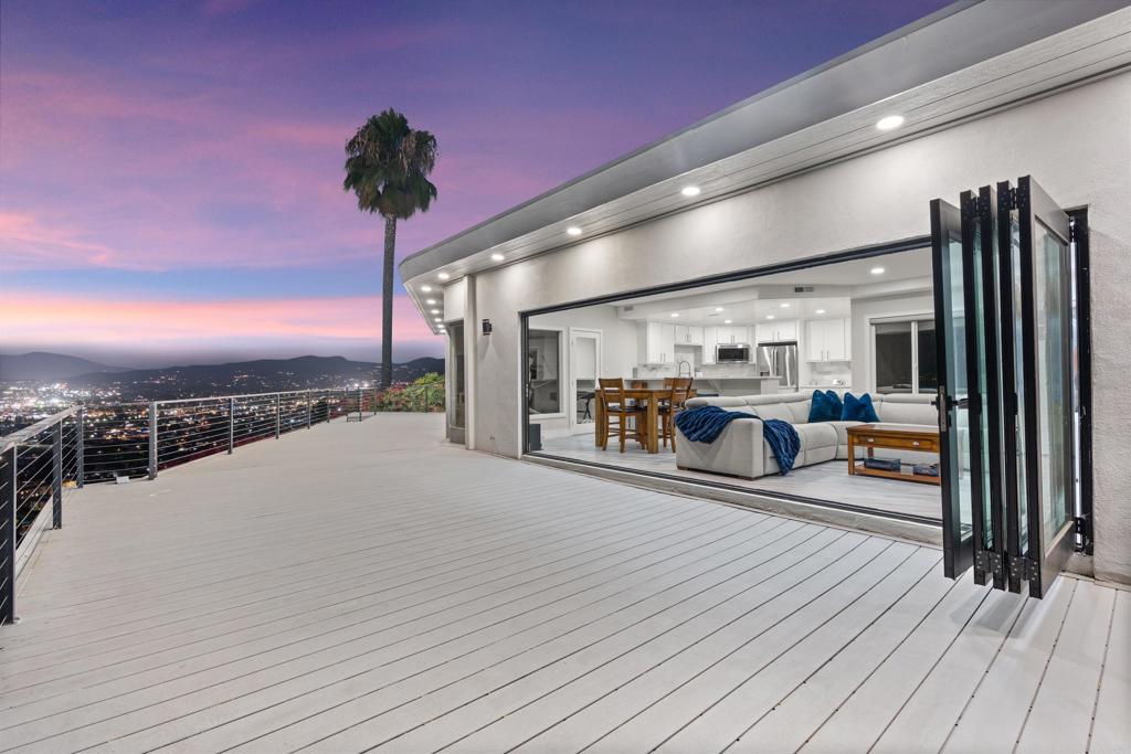 Possibly the most epic view in all of San Diego, this Mount Merritt retreat offers a breathtaking 280 degree panorama view of city lights and mountains. Slide open the 19-ft cantina door and watch the sunset from your very own private deck. This move in ready home has many modern upgraded including: Quartz countertops, luxury vinyl flooring, Smart color changing lighting throughout the entire house, Spa-style bath, Bluetooth bathroom speaker, Ecobee temperature control, High capacity washer and dryer, Ev charging outlet, New garage door, Secret fireplace mantel, Hunter Douglas sheer shades and much more! With a 2-car garage, massive driveway, newly landscaped 3/4-acre lot and approved plans for a master bathroom suite, this is a must see. This is a very unique home that makes every day feel like a getaway. Owner took exceptional care of this home and it shows.