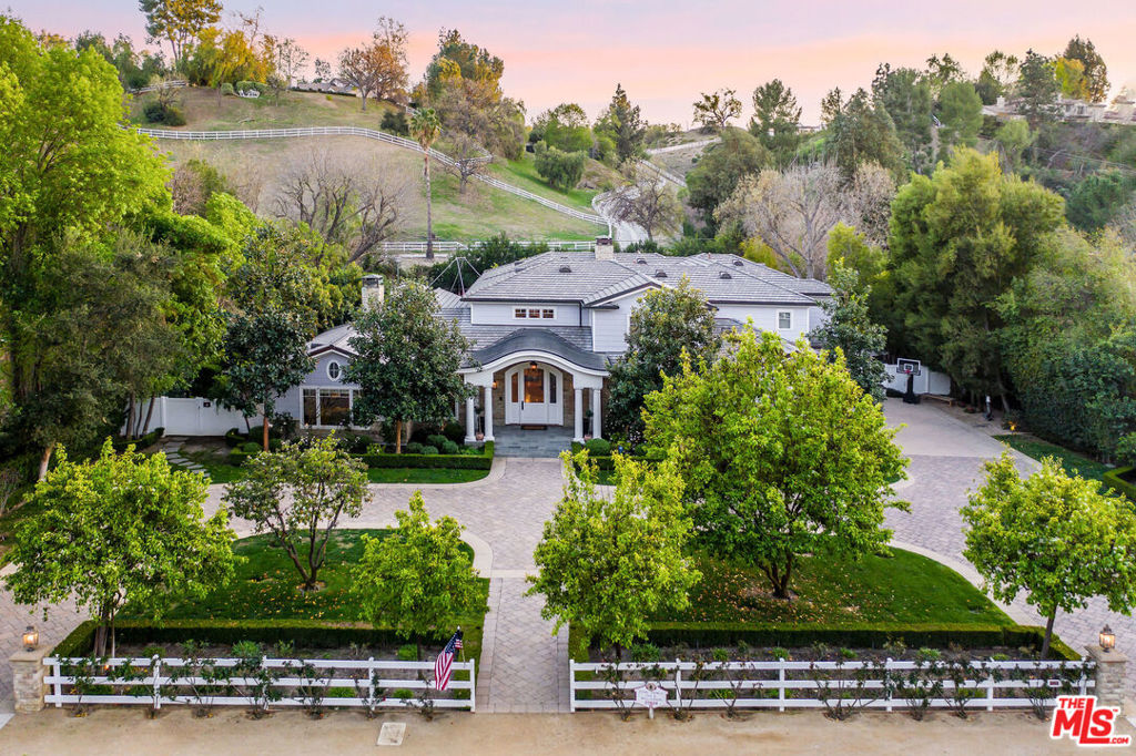 Incomparable, stunning newer, custom contemporary masterpiece. Perfectly sited on an idyllic 49,000 sq. ft. flat lot. An Estate property that stirs emotions with natural light flowing throughout & mountain vistas from the rear providing ultimate serenity & privacy. Located in the ultra-safe guard gated & patrolled exclusive community of Hidden Hills. Featuring 6 bedrooms (all en-suite / 2 on lower level) plus study/library & home theatre room. A grand eat-in Chefs kitchen with Marble counters, two islands & commercial grade (Wolf, Sub-Zero) appliances opens to the great room. A true butlers pantry open to the formal dining room. The grand foyer is ideal for greeting guests into this warm home with an exceptional floor plan that has been carefully designed with every feature imaginable for a large scale family living & entertaining. The stunning Master Suite offers a large walk-in closet, sumptuous bath overlooking the lush rear yard & pastoral views. The fit & finish of the entire home is beyond compare with elements such as: soaring voluminous ceilings, walnut wood flooring & Calcutta Marble. The ultra-private entertainers dream yard has a beautiful large veranda, pool with Baja shelf, spa, built-in BBQ & huge, flat, grassy expanse. 4 car garage. Round Meadow School. One-of-a-kind enchanting retreat with lush landscaping & mature trees.