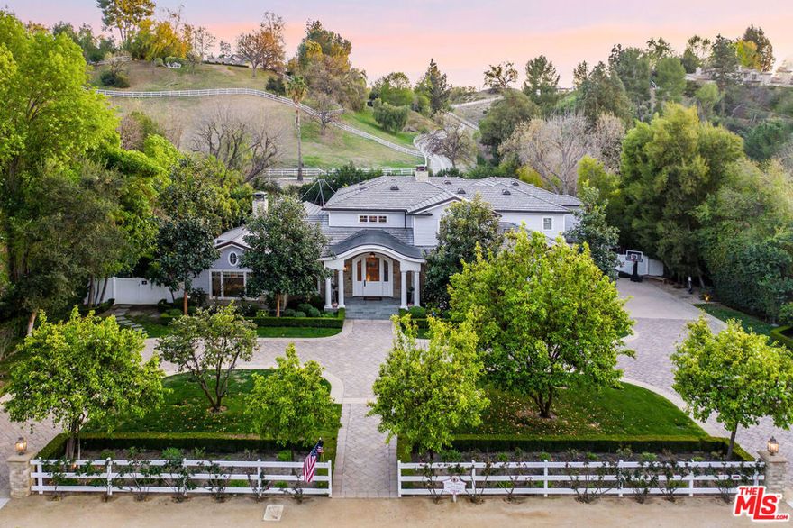 Incomparable, stunning newer, custom contemporary masterpiece. Perfectly sited on an idyllic 49,000 sq. ft. flat lot. An Estate property that stirs emotions with natural light flowing throughout & mountain vistas from the rear providing ultimate serenity & privacy. Located in the ultra-safe guard gated & patrolled exclusive community of Hidden Hills. Featuring 6 bedrooms (all en-suite / 2 on lower level) plus study/library & home theatre room. A grand eat-in Chefs kitchen with Marble counters, two islands & commercial grade (Wolf, Sub-Zero) appliances opens to the great room. A true butlers pantry open to the formal dining room. The grand foyer is ideal for greeting guests into this warm home with an exceptional floor plan that has been carefully designed with every feature imaginable for a large scale family living & entertaining. The stunning Master Suite offers a large walk-in closet, sumptuous bath overlooking the lush rear yard & pastoral views. The fit & finish of the entire home is beyond compare with elements such as: soaring voluminous ceilings, walnut wood flooring & Calcutta Marble. The ultra-private entertainers dream yard has a beautiful large veranda, pool with Baja shelf, spa, built-in BBQ & huge, flat, grassy expanse. 4 car garage. Round Meadow School. One-of-a-kind enchanting retreat with lush landscaping & mature trees.