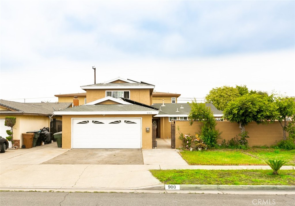 West Anaheim Beauty! Step into this charming single-family residence, designed for modern living and ultimate comfort. The inviting entry features a beautiful front door with a wood-and-glass design, setting a warm and elegant tone. Wood flooring flows throughout, paired with tile in the kitchen, bathrooms, and laundry room. Crown molding and recessed lighting enhance the home's stylish appeal. The open floor plan includes a formal living room perfect for entertaining, while the bright kitchen shines with upgraded granite countertops, a functional breakfast bar, and a spacious dining area. Relax in the cozy family room with its inviting fireplace, or retreat to the primary suite complete with a private bathroom.
Step outside to your private backyard oasis, featuring a sparkling in-ground swimming pool, soothing spa, and a covered patio ideal for summer gatherings and BBQs. Energy-efficient solar panels help keep utility costs down while you enjoy year-round comfort. The attached 2-car garage provides ample storage and a convenient laundry area.
This SFR is uniquely configured with two partitioned living spaces offering excellent flexibility:
* One partition features 3 bedrooms and 2 bathrooms, all located downstairs, along with a kitchen and laundry hookups in the garage.
* The other partition with a private separate entry features 2 bedrooms and 2 bathrooms, with one of the bathrooms and the laundry room located downstairs, plus a newly remodeled kitchenette area. This setup is ideal for extended family, guests, or potential rental income.
Perfectly situated near Disneyland, Knott's Berry Farm, shopping centers, dining, and offering quick access to the 5 and 91 freeways, this Anaheim gem combines comfort, versatility, and convenience.
Don’t miss this incredible opportunity—schedule your private showing today!