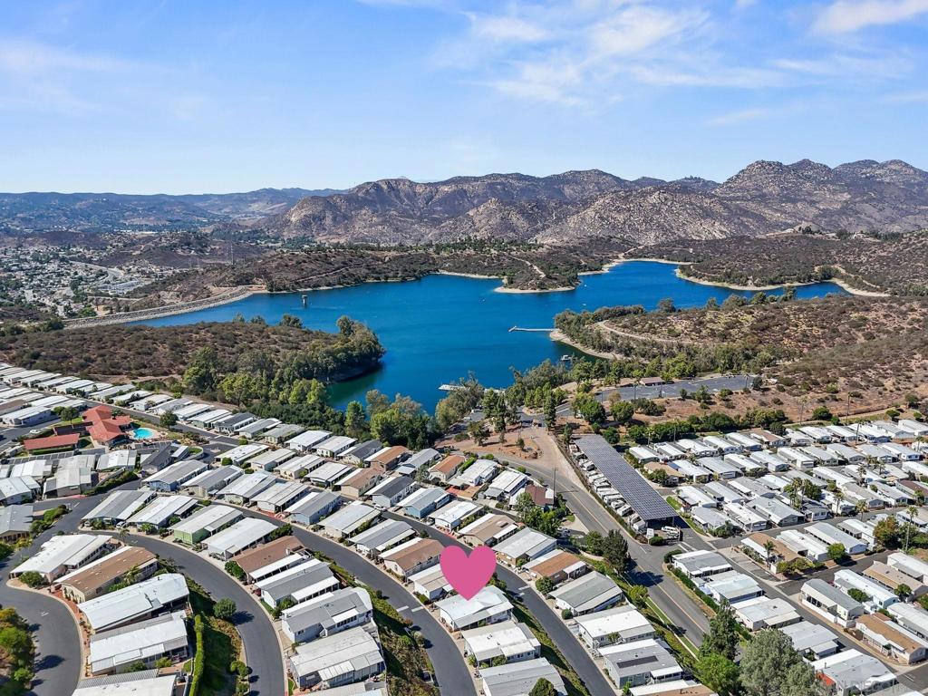 Gorgeous VIEWS of Mountains & Lake-Night Lights!! Well Maintained home at Lake Jennings Park Estates-55+ Community (w/LAND Ownership). Spacious 2BR/2BA w/BONUS (Office/Sunroom, or?) Lg Living/Dining/Kitchen Areas w/Beautiful Views that OPENS to Lg Tiled & Covered Deck to Relax (Room for Lounge+Dining Outside) and Enjoy those Lovely Views Morning through Add'l Yard area (Huge Tangerine Tree) for Plants, etc... Sep Large Storage/Workshop-Room. Park has Lots of great Amenities, including Pickleball!