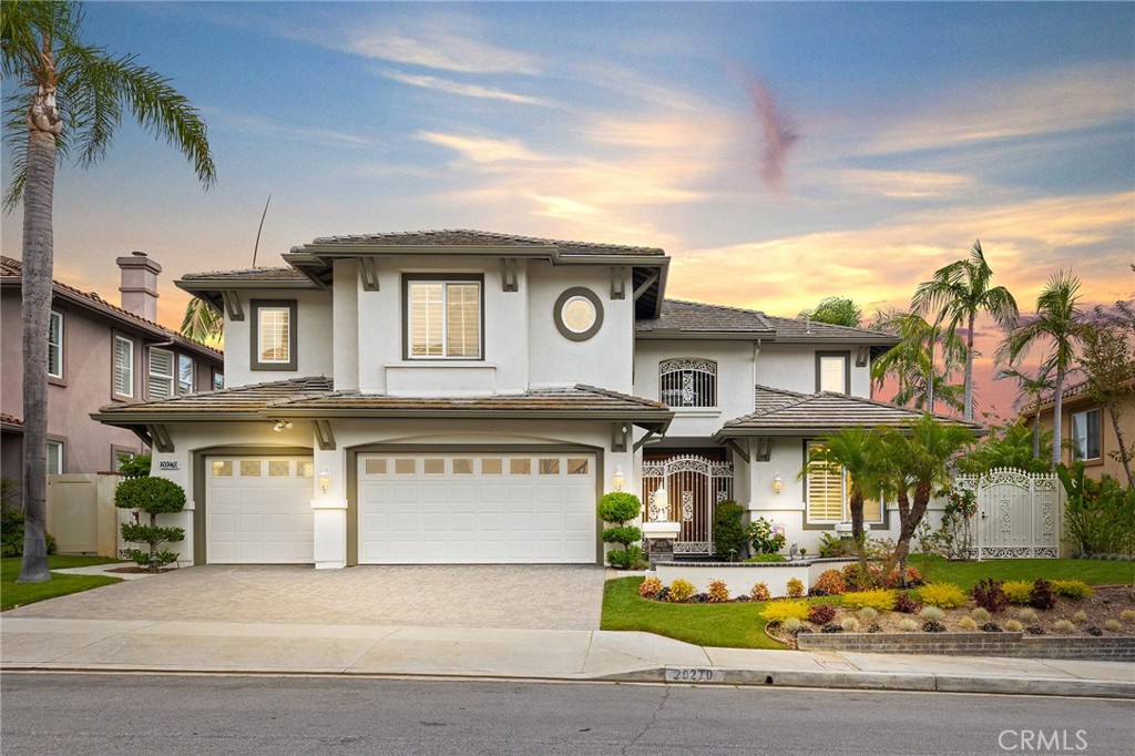 Welcome to East Lake Village living in Yorba Linda. Located on a quiet cul-de-sac street, this beautifully upgraded 4,002 sqft home offers 4 bedrooms and 3.5 bathrooms, including a main-floor bedroom with a full bath that’s perfect for guests or multigenerational living, or a private office suite. Inside, you'll find soaring ceilings, abundant natural light, and a spacious layout with formal living and dining rooms, a large family room, and a chef’s kitchen featuring double ovens, a Sub-Zero refrigerator, granite countertops, and generous prep space. A wine cellar adds a luxurious touch, while the upstairs bonus room includes a built-in bar ideal for entertaining. The expansive primary suite boasts a spa-like bathroom, a walk-in closet, and stunning views of the surrounding hills. Two additional bedrooms share a Jack and Jill bathroom, and the 3-car garage offers plenty of storage. Enjoy all the amenities East Lake Village has to offer, including a private 15-acre lake, multiple pools, tennis and sport courts, a fitness center, clubhouse, and scenic walking trails, all with a low tax rate and low HOA. Just minutes from top-rated schools, shopping, dining, and parks, this is an incredible opportunity to live in one of Yorba Linda’s most desirable communities.