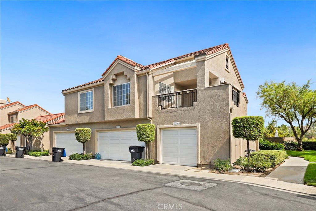 Welcome to 22068 Antigua, a charming carriage unit located in the desirable Coral Gardens neighborhood of Mission Viejo. This residence offers two bedrooms and 1.25 bathrooms, with the living space conveniently situated above the attached garage. A spacious front deck creates the perfect outdoor retreat before stepping inside to vaulted ceilings and wood flooring throughout. The living room, complete with a cozy fireplace, opens seamlessly to the dining area. The kitchen features granite countertops and easy access to the main living spaces. The primary suite boasts vaulted ceilings and an ensuite bath, while the secondary bedroom is adjacent to the full bathroom. Residents enjoy access to community amenities including a pool, spa, and tennis courts, as well as Mission Viejo Lake privileges with summer concerts and year-round activities.
