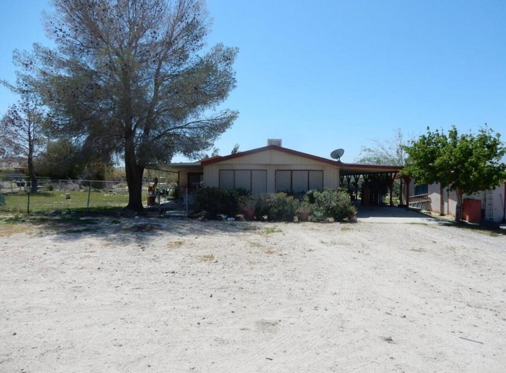 Sky Valley Ranch is situated on 2.59 acres fenced in property. This is a manufactured home. This is a 3 bedroom 2 bath, kitchen, living room, dining area, plus office or den area. Also includes 2 separate 2 car garages detached. One could be converted to an ADU maybe both have concrete driveways. Previous owner had horses here - with hay shed and additional covered area.