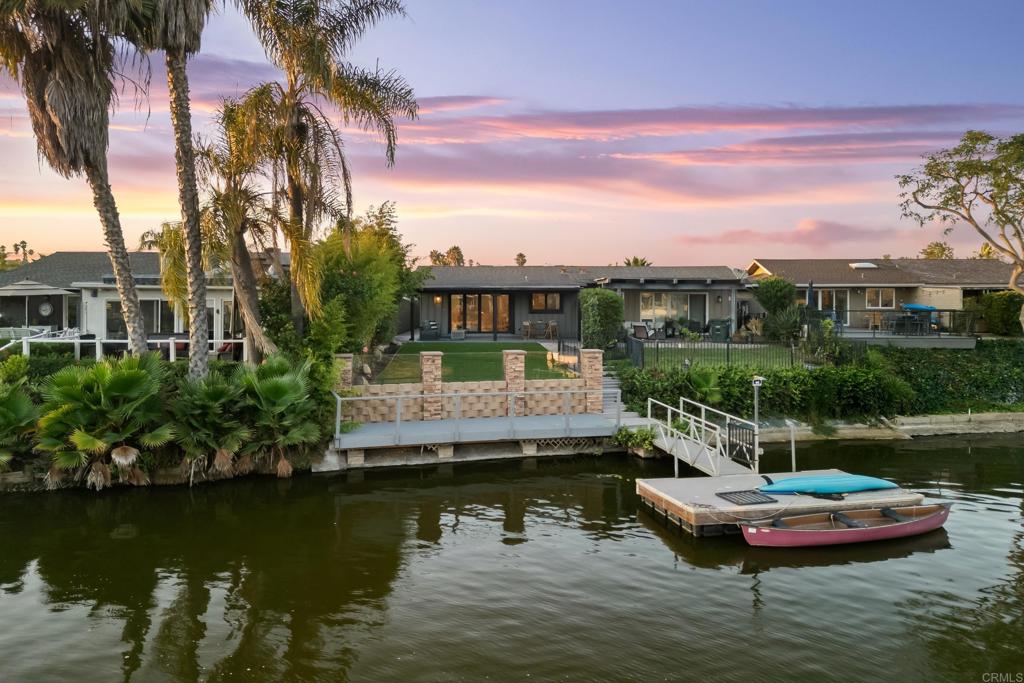 Live lakeside luxury every day in this breathtakingly remodeled Lake San Marcos home. This 3-bedroom, 2-bath retreat is where modern design meets relaxed waterfront living. Just outside your backyard, a private shared boat dock with sitting area invites morning paddles, afternoon fishing, or sunset cruises right from home. Unlike many lakeside properties, this one offers its own usable backyard — a rare bonus perfect for entertaining, dining under the stars, or simply unwinding by the water. Inside, no detail has been overlooked. The open-concept design features a chef’s kitchen with quartz countertops, sleek stainless appliances, and designer finishes. Expansive breakaway doors blur the line between indoors and outdoors, filling the home with natural light and framing tranquil lake views. The primary suite is a spa-like haven with a freestanding tub and luxurious en suite bath, creating the ultimate space to recharge. With its lakeside dock, private backyard, and showpiece remodel, this home is truly one of Lake San Marcos’ finest offerings.