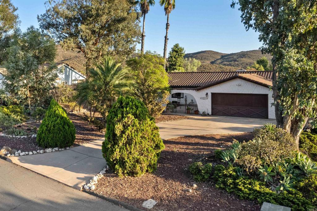 Tremendous opportunity in this spacious single-story 3-bedroom, 2-bath home with an attached two-car garage on nearly half an acre in much desired San Diego Country Estates! From the moment you walk in, you’re greeted with abundant natural light and an open layout that frames spectacular mountain views. The spacious design flows into a large kitchen with generous counter space and storage, separate dining area, and a huge living room featuring a cozy fireplace and southern mountain views, perfect for entertaining. Spacious master with separate retreat, and ample sized secondary bedrooms with plenty of closet space. Upgraded flooring in kitchen, dining room, and all bedrooms, with tile in living room and both bathrooms. Ceiling fans and some upgraded lighting, fresh paint, popcorn ceilings removed. Step outside to a private backyard featuring a covered patio where you can relax and take in the scenic beauty of the highly desirable San Diego Country Estates community. SDCE offers resort-style amenities, including pool and spa, clubhouse with restaurant/bar, fenced playground, community RV storage, dog park, picnic areas with BBQs, equestrian center, basketball courts, and miles of hiking and horse trails — all just minutes from the San Vicente Golf Course. FULLY PAID SOLAR! Optional boat or RV storage parking may be possible with the addition of fencing. Don’t miss this opportunity to make San Diego Country Estates your home!