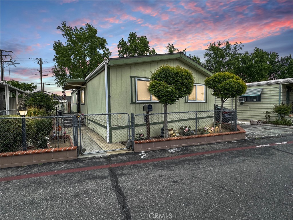 Back on the market!! Updated Double-Wide Mobile Home in Rialto offering 3 bedrooms and 2 bathrooms in a well-maintained community with a community swimming pool recreation area. Move-in ready home has fresh interior and exterior paint, a new roof less than a year old, and newer dual pane windows for energy efficiency. Open floor plan with laminate wood flooring throughout, a spacious living room, and a separate dining area. The updated kitchen has a stylish backsplash, both bathrooms have been updated. Ceiling fans in each bedrooms and a newer central A/C and heating system. Separate interior laundry room. Has a long covered carport fits two vehicles, fenced yard includes a storage shed and a lush setting with flowers, plants, and fruit trees..
Centrally located near shopping centers, restaurants, schools and freeway.