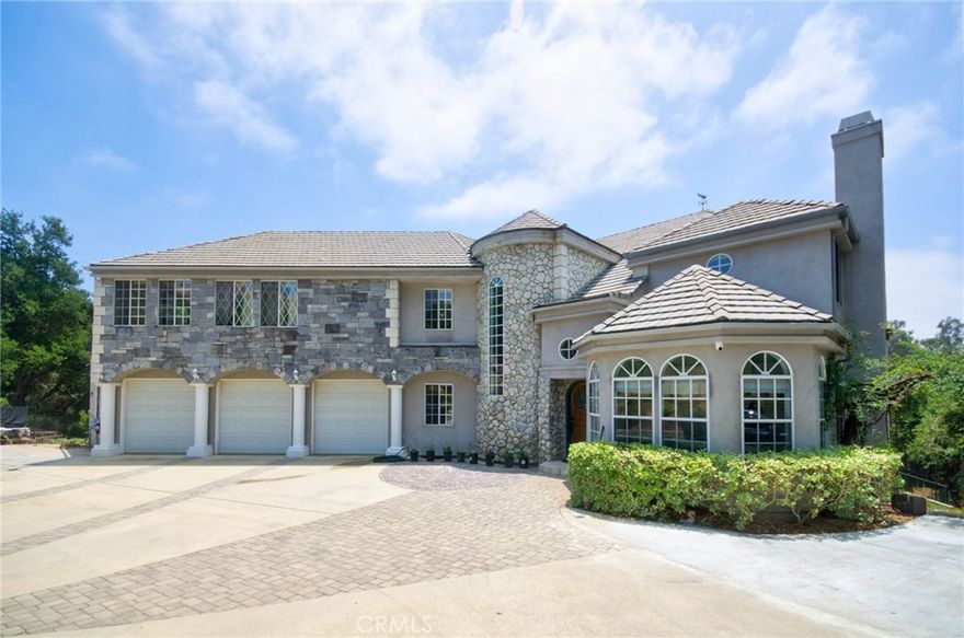 Welcome to your dream retreat in the prestigious gated community of Oak Tree Downs—where privacy, elegance, and nature come together in perfect harmony.  This custom-built estate offers 7 bedrooms and 5.5 bathrooms, including a main-floor suite with its own bath, a dedicated home office, and an impressive private movie theater that can easily serve as the sixth bedroom.  One of the Second Floor room can also be converted to be the seventh bedroom.  The gated driveway leads to a grand entrance, revealing a sophisticated living room with a fireplace and a formal dining area adorned with a designer chandelier and French doors opening to a bi-level expansive deck—ideal for unforgettable entertaining.  The chef’s kitchen is a masterpiece, featuring granite countertops, a walk-in pantry, breakfast nook, and top-of-the-line stainless steel appliances including a Viking 6-burner stove with griddle and double oven, two dishwashers, and a built-in microwave.  The soaring 18-foot ceilings continue into the family room with a dramatic stone fireplace, filling the space with light and warmth.  Upstairs, the luxurious master suite invites relaxation with its retreat area and marble fireplace, while the spa-style bathroom offers dual walk-in closets, double sinks, a jacuzzi tub, and a separate shower.  A Jack and Jill suite with its own balcony adds to the home’s family-friendly layout. Downstairs, the fully functional lower level includes a separate entrance, full kitchen, living and dining areas, laundry, private suite, and theater perfect for multigenerational living or extended guest stays.  This home is filled with high-end finishes: wood flooring in main areas, plush carpet in bedrooms, custom chandeliers, recessed lighting, elegant drapery, and designer paint throughout. The beautifully landscaped backyard is a peaceful oasis with mature trees, a serene water fountain, and direct access to nearby horse trails.  All of this, tucked away in a quiet, tree-lined setting that feels a world apart—yet just minutes from top schools, shopping, and major freeways. Don’t miss this rare opportunity to own a one-of-a-kind estate where luxury meets lifestyle. Make it your very own Home-Sweet-Home today.