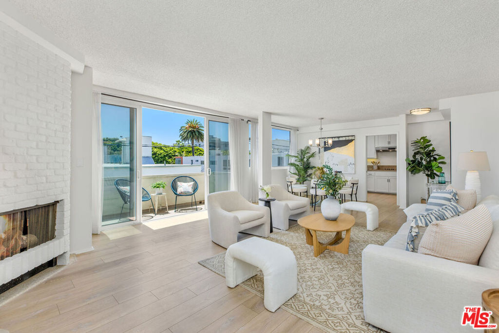 Minutes from the best of Santa Monica living, this TOP FLOOR, light-filled, and west-facing condo offers breathtaking ocean breezes and stunning sunsets. Spanning 1,355 sq.ft., this single-story, 2-bedroom, 2-bathroom home provides the perfect retreat from the hustle and bustle of city life.The inviting double-door entry opens into a spacious, sun-drenched living room and dining area with access to a private deck. Sliding glass doors allow the ocean breeze to flow in, while providing peek-a-boo views of the ocean. The updated kitchen is a chef's dream, featuring stainless steel appliances and plenty of storage space for all your culinary essentials. Enjoy preparing home-cooked meals in a serene and stylish setting.The well-appointed main bedroom suite includes two large closets, an en-suite bathroom, and a flexible space that can serve as an office or reading nook. The generously sized second bedroom also boasts wall-to-wall closet space, offering comfort and versatility. Located in a world-class neighborhood, this condo is within close proximity to trendy shops and restaurants on Montana Avenue, Santa Monica Beach, and situated within a distinguished school district. HOA DUES include: water, sewer, trash, building maintenance, insurance (including earthquake insurance), bike storage in an alcove on 1st floor, fireplace gas paid by HOA, and access to the community pool. The unit also includes one underground parking space and an assigned storage unit. Don't miss out on this exceptional opportunity in a prime Santa Monica location!