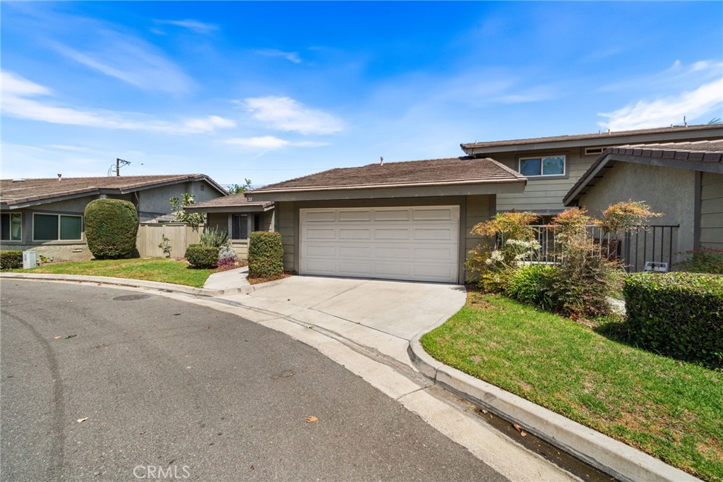 Welcome to 211 E. Ponderosa Lane, a stylish and inviting single-story townhome tucked inside the quiet, gated community of Ponderosa Meadows in Anaheim with a pool and cabana. This light-filled 2-bedroom, 2-bath residence offers approximately 1,300 square feet of thoughtfully designed living space, perfect for both relaxing and entertaining. The open-concept layout features soaring vaulted ceilings, recessed lighting, and a cozy fireplace that sets the tone for comfort. The dining area flows seamlessly into the kitchen, complete with an eating bar and a sunny breakfast nook for casual mornings. Both bathrooms have been tastefully updated, and the spacious bedrooms provide a peaceful retreat at the end of the day. Step outside to a charming, covered patio ideal for BBQs, alfresco dining, or simply unwinding with your favorite book. Perfect as a starter home or an ideal next chapter for those looking to simplify, this townhome offers a blend of style, comfort, and convenience—close to shopping, dining, UCI Medical Center, The Crystal Cathedral, and offering easy freeway access—all within a serene, gated neighborhood. Welcome home!