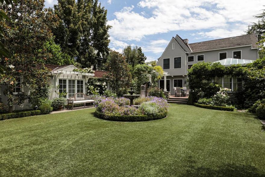 With roots dating back to 1926, this English Tudor presents a stunning transformation into designer elegance for 21st century living. This premier setting is on a highly sought-after block in the heart of Old Palo Alto.  The main house has 4 bedrooms upstairs while a beautiful ~260 SF detached studio guest house is adjoined by a ~305 SF outdoor loggia with fireplace & heaters. The enchanting English gardens, designed by Katsy Swan, include flowering trees, lavender beds, and verdant foliage. The chic, sophisticated style offers sumptuous interiors, exceptional outdoor living space, a guest house, and a drought-tolerant synthetic lawn. The highest quality La Cornue gas range takes center stage in the kitchen, an inviting family room could also serve as today's home office, and the dramatic all-glass conservatory creates year-round living space under the sun and stars. Highly acclaimed Palo Alto schools add the finishing touch as well as proximity to Stanford University.