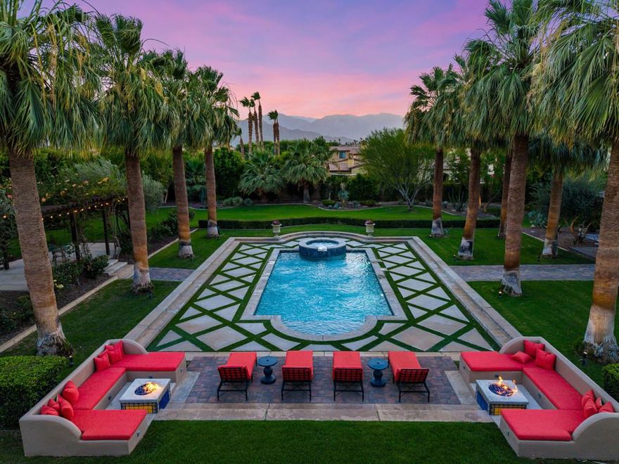Imagine entering through a majestic, gated entry lined with towering Palm Trees to an extraordinary Estate that exudes unparalled luxury and exquisite style. This Elegant Spanish residence is known as Casa Del Sueno or Dream House, a tranquil luxury Estate located in the exclusive gated enclave of La Quinta Polo Estates.  Meticulously kept, the property blends Old World Charm with modern elegance, and offers breathtaking views of the Santa Rosa Mountains, expansive indoor/outdoor entertaining spaces and resort-style amenities including a sparkling pool & spa surrounded by swaying, majestic palm trees, two custom stone firepits with built in cushioned lounge seating adjacent to a two bedroom guesthouse & grand outdoor living room with custom stone fireplace to enjoy evenings under the stars.  Casa Del Sueno is set on over 2 acres with sprawling lawns, stone walkways, lush, verdant landscaping, mature shade trees, an orchard, garden, vibrant bougainvillea & tropical plants, grape vines over pergolas which creates an inviting & serene oasis.  This home is designed to offer ample space with multiple outdoor terraces, 3 guesthouses, cozy media room w/fireplace, bar & wine cellar. An expansive covered outdoor loggia and enchanting fountain as the centerpiece connects the guesthouse & media room to the main house, perfect for evenings relaxing in front of a crackling fire while playing billiards or lawn games surrounded by romantic hanging lights softly illuminating the area.  This exquisite Estate offers 5 bedrooms w/ensuite baths, 7 bathrooms, chef's luxury kitchen perfect for effortless entertaining, butler's pantry, an elegant living room w/massive stone fireplace & floor to ceiling walls of glass and French doors that opens to a grand terrace & outdoor dining room/living area w/seating for 30+, outdoor kitchen, BBQ, & Poolside Bar. The master suite is a true retreat with 2 bathrooms, dressing room, living room and provides incredible views of the lush grounds & shimmering pool with French doors to a private covered terrace. This exceptional property includes superb architectural elements & sumptuous furnishings throughout.  Adjacent to Eldorado Polo Club, the Hideaway & Madison, this hidden gem offers a Magnificent setting with spectacular views that provide a stunning backdrop to unwind & enjoy the beauty of the desert.  This is a priceless opportunity to own a special piece of the Polo Estates, the finest real estate in La Quinta the Desert has to offer.