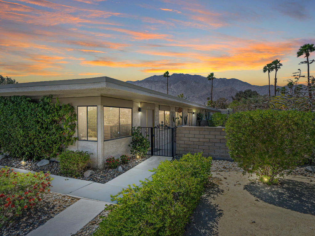 Live the Palm Springs Dream at Sagewood - Truly Exceptional Value. Discover the perfect blend of style, comfort, and outdoor living in this Donald Wexler-designed mid-century condo at Sagewood -- a community of just 108 residences thoughtfully spread across nearly 19 acres, making it one of the lowest-density HOA communities in Palm Springs. This 1,248 sq. ft. end-unit is more than a home -- it's a lifestyle, and it's priced to deliver exceptional value in today's market. Wake up to mountain views, enjoy your morning coffee on a private patio shaded by Australian Mallee trees, and step into a community designed for relaxation and connection. With direct patio access from every room, this rare pinwheel floor plan makes indoor-outdoor living effortless. Sagewood's sweeping greenbelts, mature desert landscaping, and vibrant gardens create a serene, park-like setting -- yet you're just minutes from downtown Palm Springs, world-class dining, and desert events. Inside, you'll find 2 bedrooms, 2 baths, and a flexible bonus room perfect for a third bedroom, office, or media lounge. Original walnut veneer cabinetry, timeless tile flooring, and a recently installed new HVAC system combine vintage character with modern comfort. Spend your days lounging by one of three sparkling pools, meeting neighbors for a game of pickleball or tennis, or hosting sunset gatherings on your patio under the desert sky. Sagewood is actively seeking historic designation, which could mean future Mills Act tax savings for homeowners. Whether you're looking for a weekend escape or full-time desert retreat, this home offers the best of Palm Springs living -- a true value that's ready to sell. Images virtually staged for inspiration.