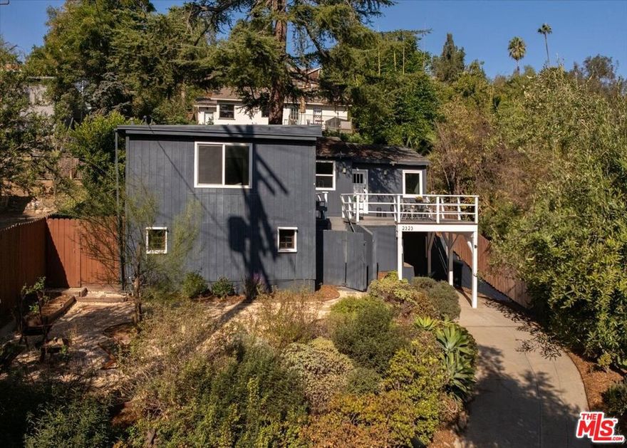 Treehouse vibes await you at this charming Bungalow nestled in Elysian Heights. An expansive deck greets you with a beautiful pine tree providing an abundance of shade and a natural woodsy environment. This delightfully updated 3-bedroom, 2-bath home offers an inviting lifestyle with its thoughtfully designed living space. Step inside to discover a warm and welcoming atmosphere, featuring picture windows with wonderful views, and beautiful floors that guide you through this charming abode. The chef's kitchen is the heart of the home, boasting sleek quartz countertops and a stylish waterfall island that makes it perfect for both casual meals and entertaining guests. The primary suite features dual closets and an updated bathroom. There is an enclosed sunroom off the dining area offering a versatile space as well as an adjacent laundry room. Outdoor enthusiasts will love the expansive deck, perfect for soaking up the sun or enjoying gatherings. An additional patio space in the rear yard provides a nice respite as well. The front yard adds a touch of greenery, offering a serene spot for gardening or relaxation. Additional basement space is easily accessible, ideal for a home office or a personal gym. This is more than just a house; it's a place you'll be proud to call home. Close proximity to local hiking trails, Lady Byrd Cafe, Elysian Heights Elementary, and all the wonderful aspects of Echo Park living.