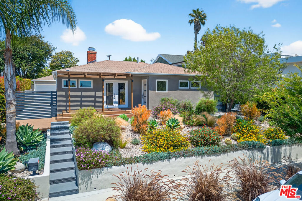 Here's your chance to lease a stunningly remodeled Sunset Park residence, thoughtfully designed and previously featured in Dwell Magazine for its creative and functional design aesthetic. This warm, open-plan home blends modern comfort with timeless materials, including oak hardwood floors, reclaimed wood baseboards, and exposed beams that accentuate the vaulted ceilings. The inviting kitchen is a focal point for both creativity and connection, featuring custom cabinetry, granite countertops, stainless steel appliances, and a porcelain farmhouse sink. It flows seamlessly into the living and dining areas, perfect for entertaining or quiet evenings at home. Step outside and discover several thoughtfully designed spaces to embrace the natural surroundings and immerse yourself in the Santa Monica coastal lifestyle. Whether you're sipping coffee under mature trees, enjoying an al fresco meal, or unwinding in the spacious backyard, this home invites you to live outdoors as much as in. Additional features include central HVAC, in-home laundry, gated parking, and a large detached 400 sq. ft. finished studio ideal for a home office, creative workspace, or guest suite. A truly special home that combines style, serenity, and the best of California living. **Please note: The garage shown in the photos is not functional for vehicle storage. Parking is available at the rear of the property on the designated parking pad, as shown.**