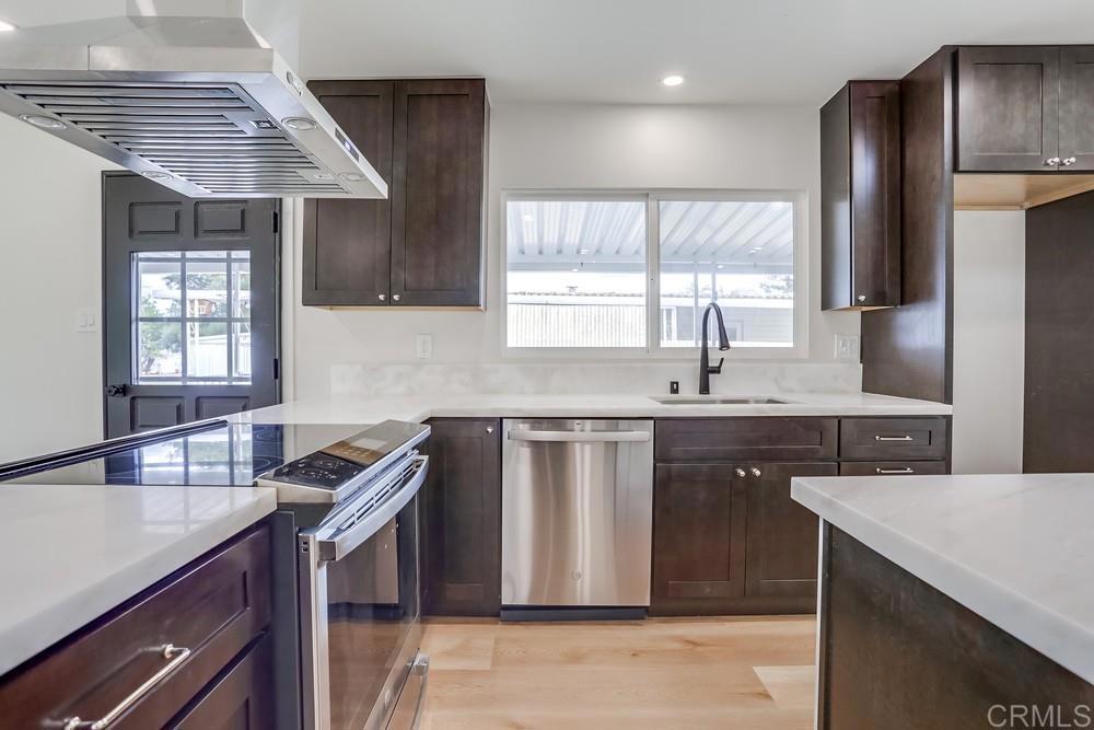 Single Story with a coveted view of the greenbelt. 55 plus community. Completely updated/renovated! Brand new kitchen: Marble counters, soft close drawer cabinets, All appliances NEW including the Refrigerator. New washer/dryer included. New 75" and 55" Smart TV's installed in living room and primary bedroom and included. New bathrooms with double sinks and tiled showers. Primary bed includes a walk in closet and ensuite new bathroom. New sheet rock throughout and freshly painted. Ceiling fans. Beautiful easy to maintain upscale luxury vinyl plank flooring throughout. Brand new AC unit and home is double insulated for efficiency. The yard includes a large trek deck and easy to maintain. Large Shed for extra storage. Water, Sewer and Trash included. Short walk to clubhouse and pool. Shopping and restaurants just a hop and a skip away. Two spaces in covered carport. Guest parking across from home. Enjoy a detached quiet home for your ultimate sanctuary. Gated after 6:00p